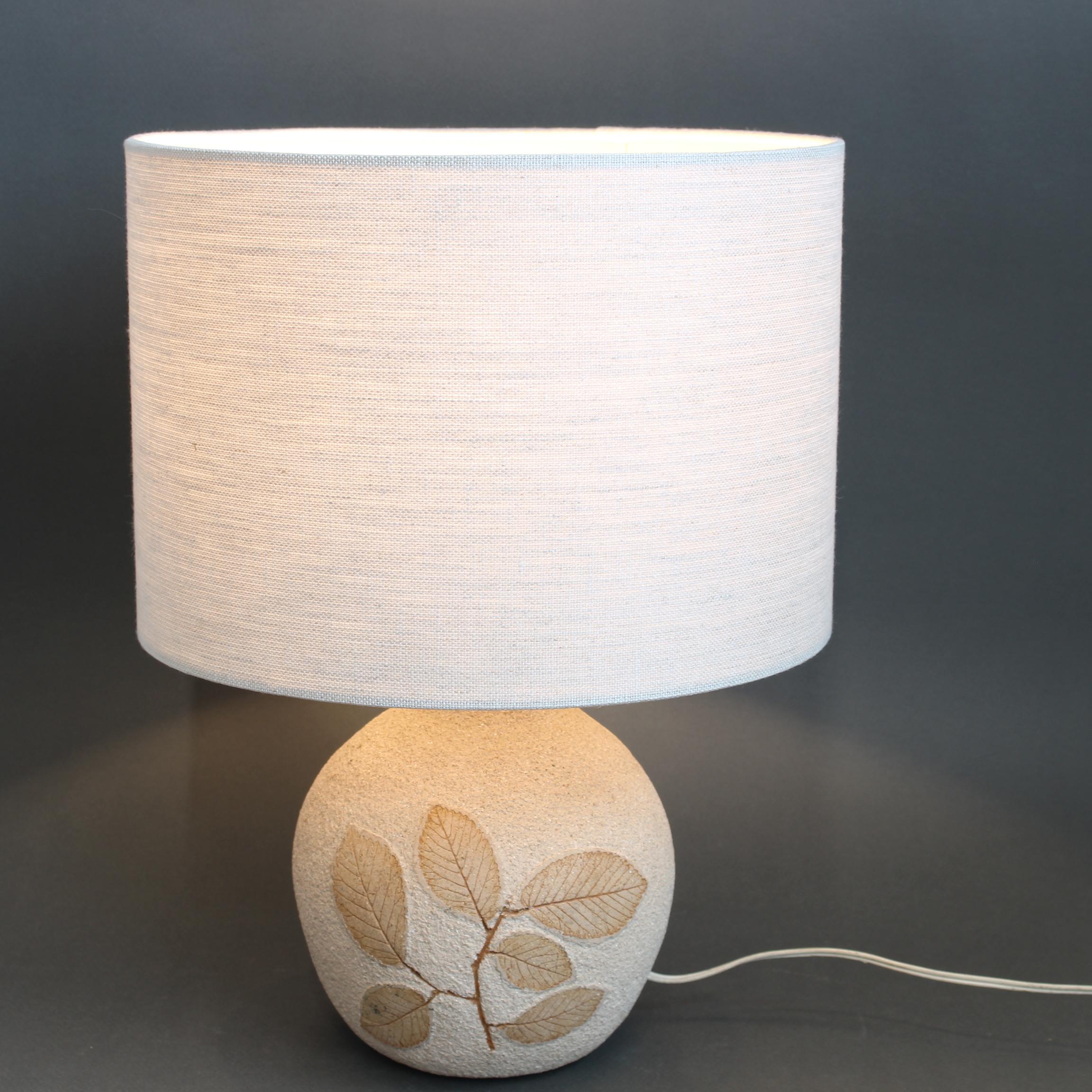 Vintage ceramic stoneware lamp base by Roger Capron (circa 1970s). Sandstone coloured and a grainy textural finish with leaf motif inlaid all on one side. A delightful gourde-shaped base which is both visually pleasing and tactile at the same time.