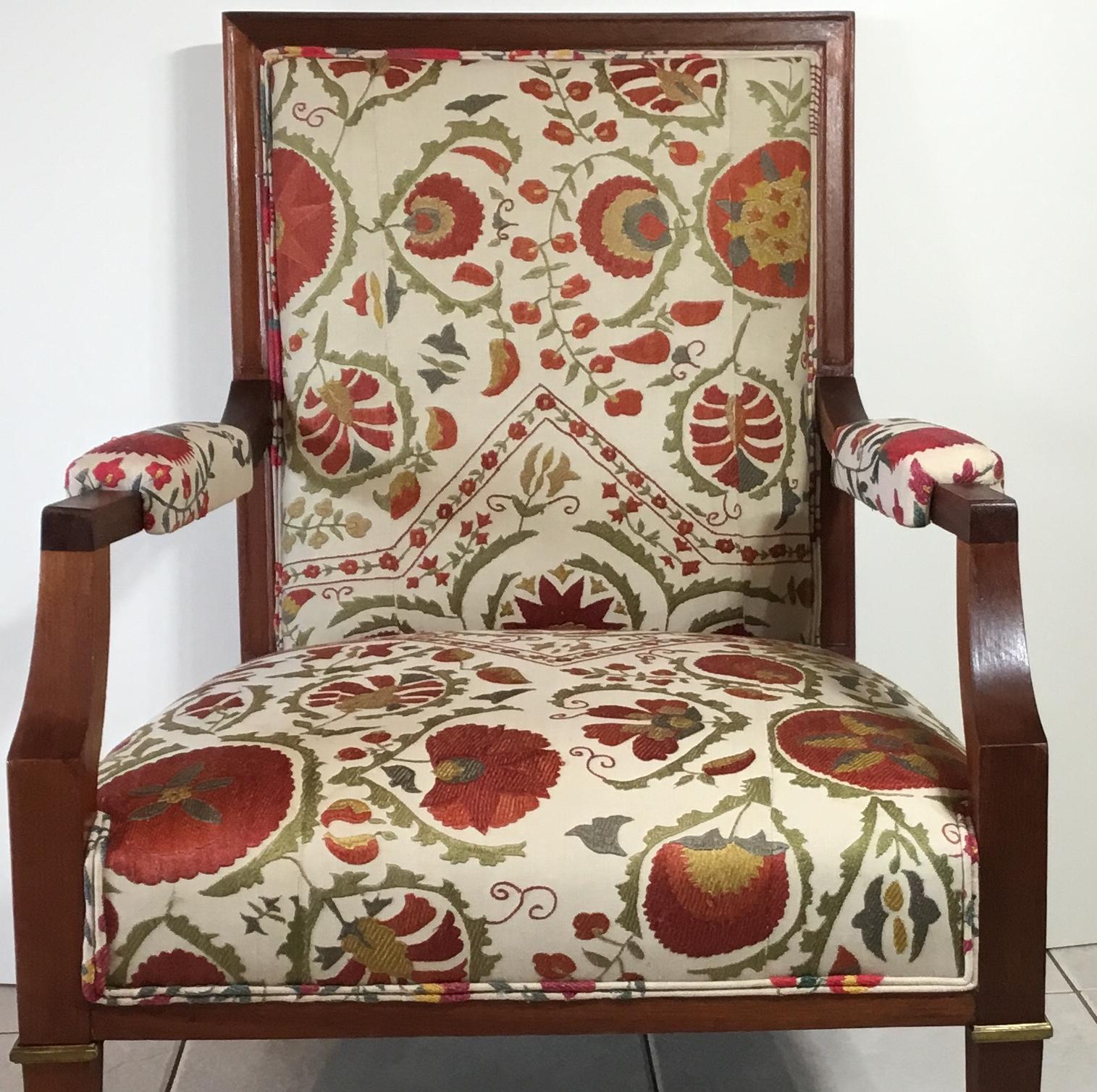 Fantastic hand carve French wood armchair from the 1940s, professionally restored, newly upholsted with beautiful vintage hand embroidery Suzani textile. The Suzani textile is silk embroidery of colorful flowers and vines motifs on a cream color