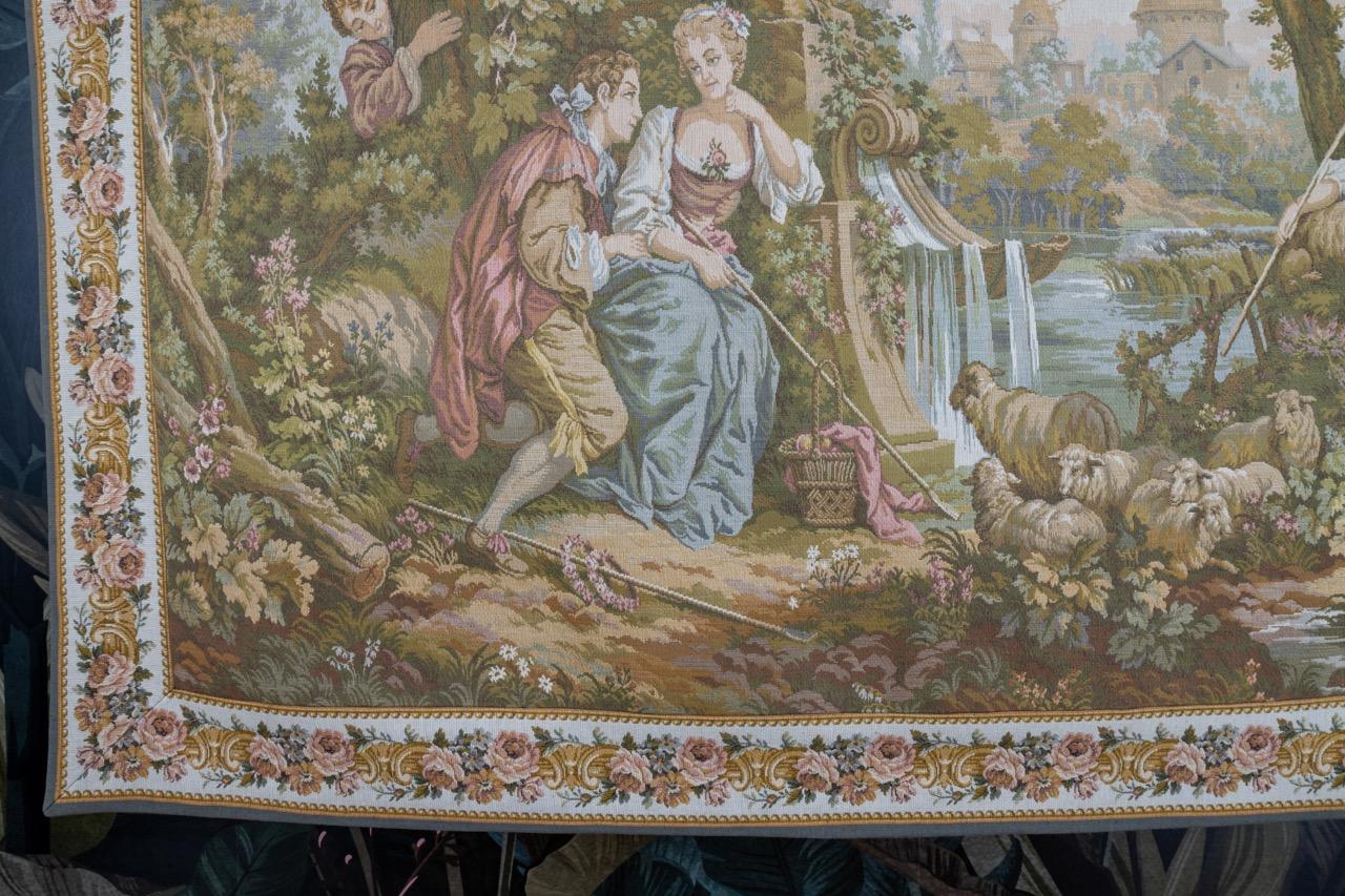 French Vintage Tapestry Gallant Scene by JP Paris Panneaux Gobelins from the late 20th century.
A beautiful French tapestry, wall hanging in Aubusson style, within a flower border featuring a gallant scene - figural scene in nature - soft colors, a