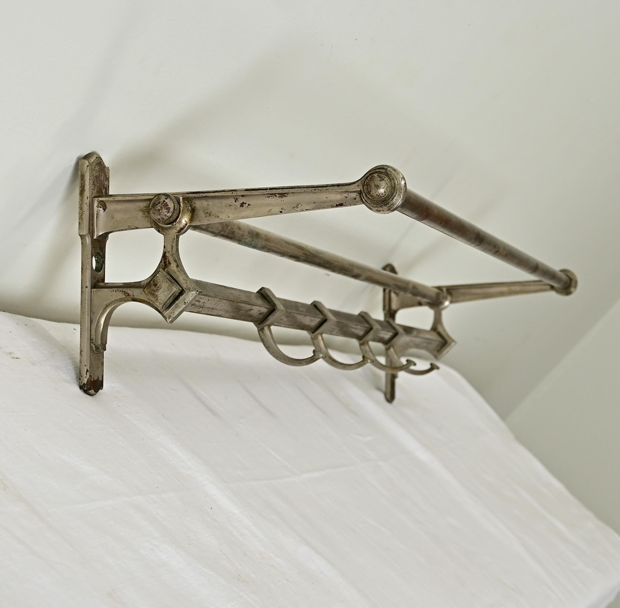 This French Art Deco style train rack would be the perfect shelf for an entryway, mudroom, or even a kitchen. Patinated, chromed steel makes for attractive and durable construction of the frame that shows classic Deco geometry. A square rail on the