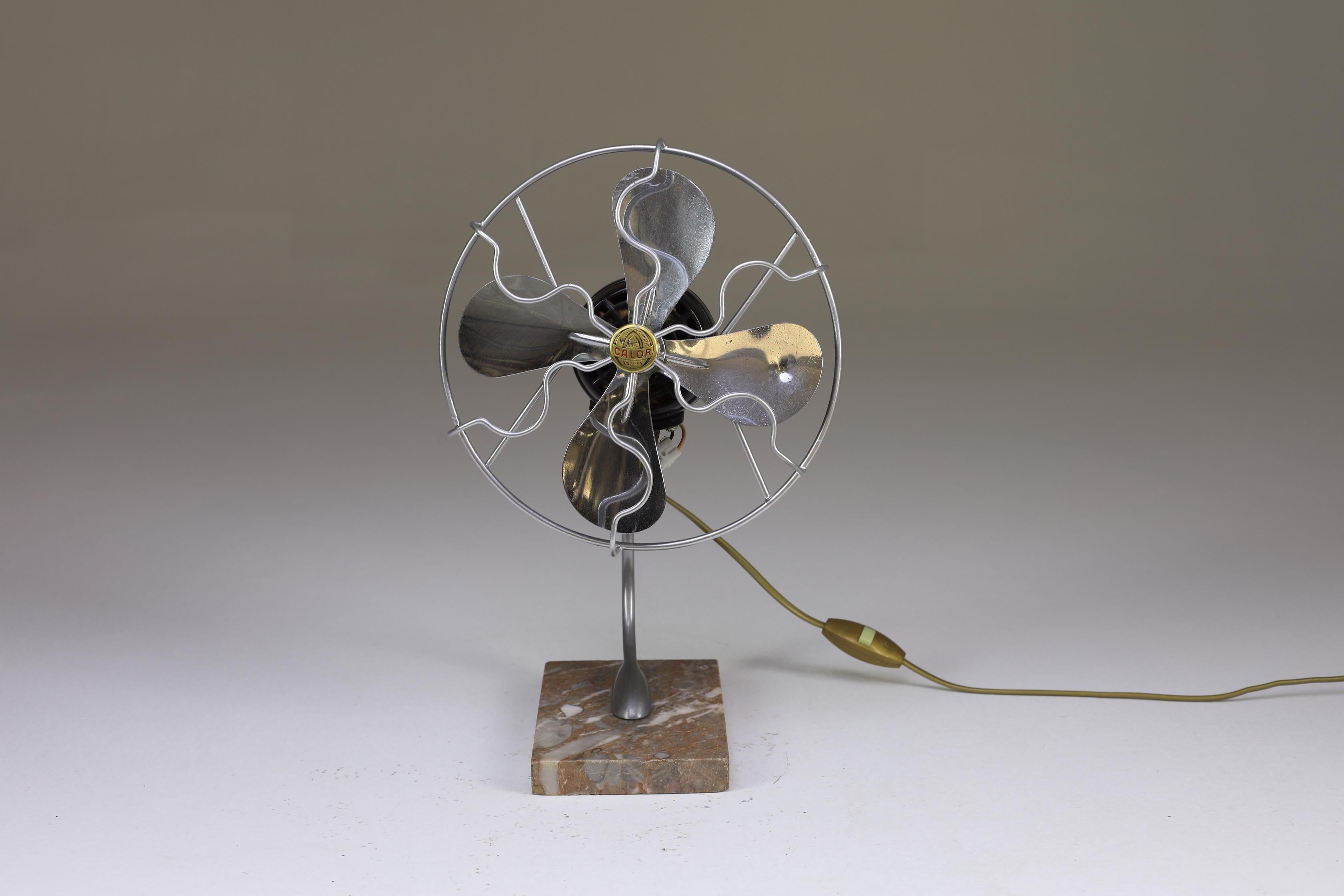 A fully functional restored small ventilator from the early 1940s. This interesting design that sits on a beautiful marble base is as much decorative as it is functional. It is rare to find a piece like this in such good condition. It works on