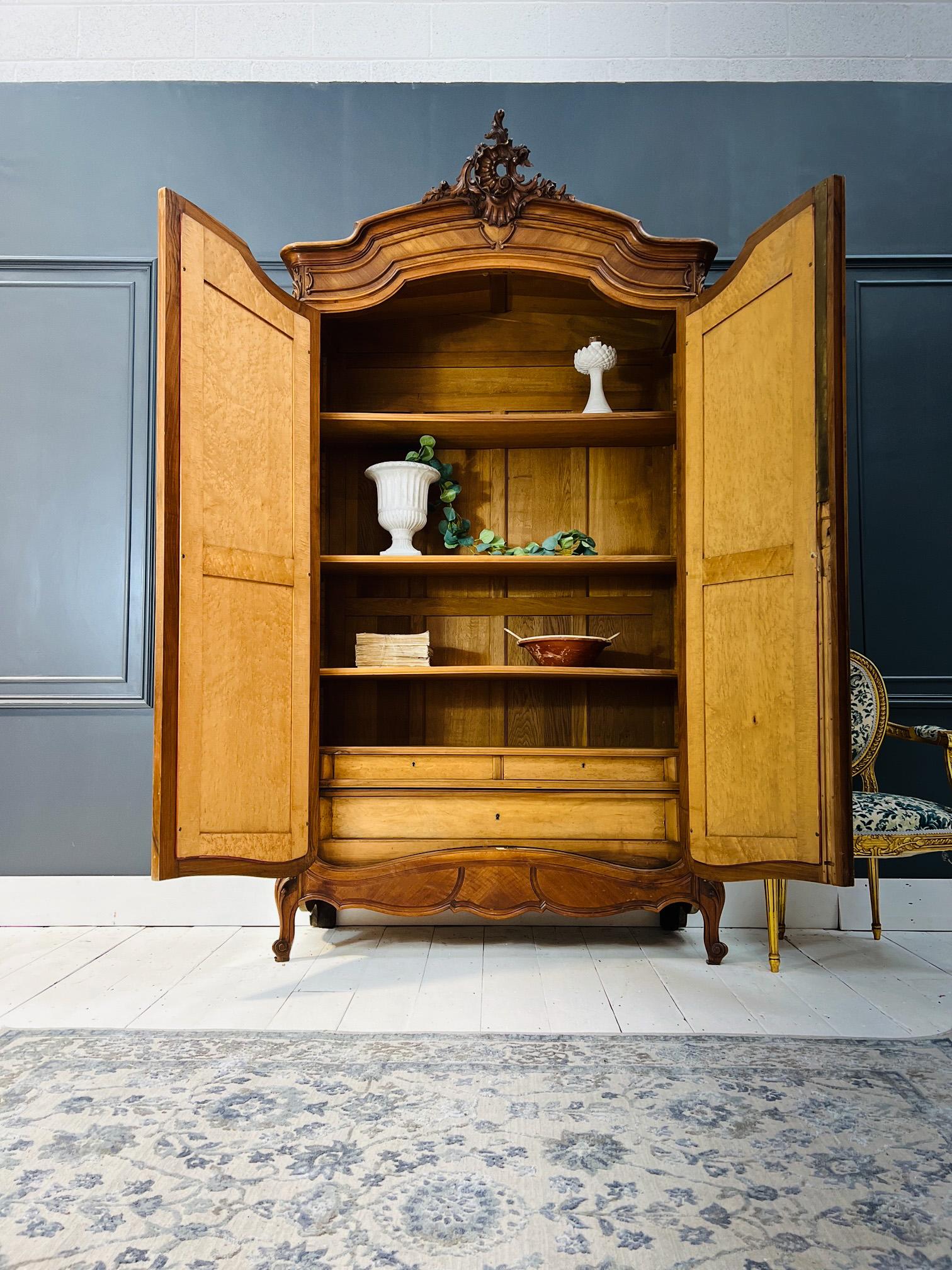 The Piece: 

A tall and sturdy Louis XV vintage armoire made of French walnut. With beautiful quarter diamond cut, this rich brown wardrobe has the most splendid of crests. Mirrored doors open to reveal a shelved interior, that can indeed be