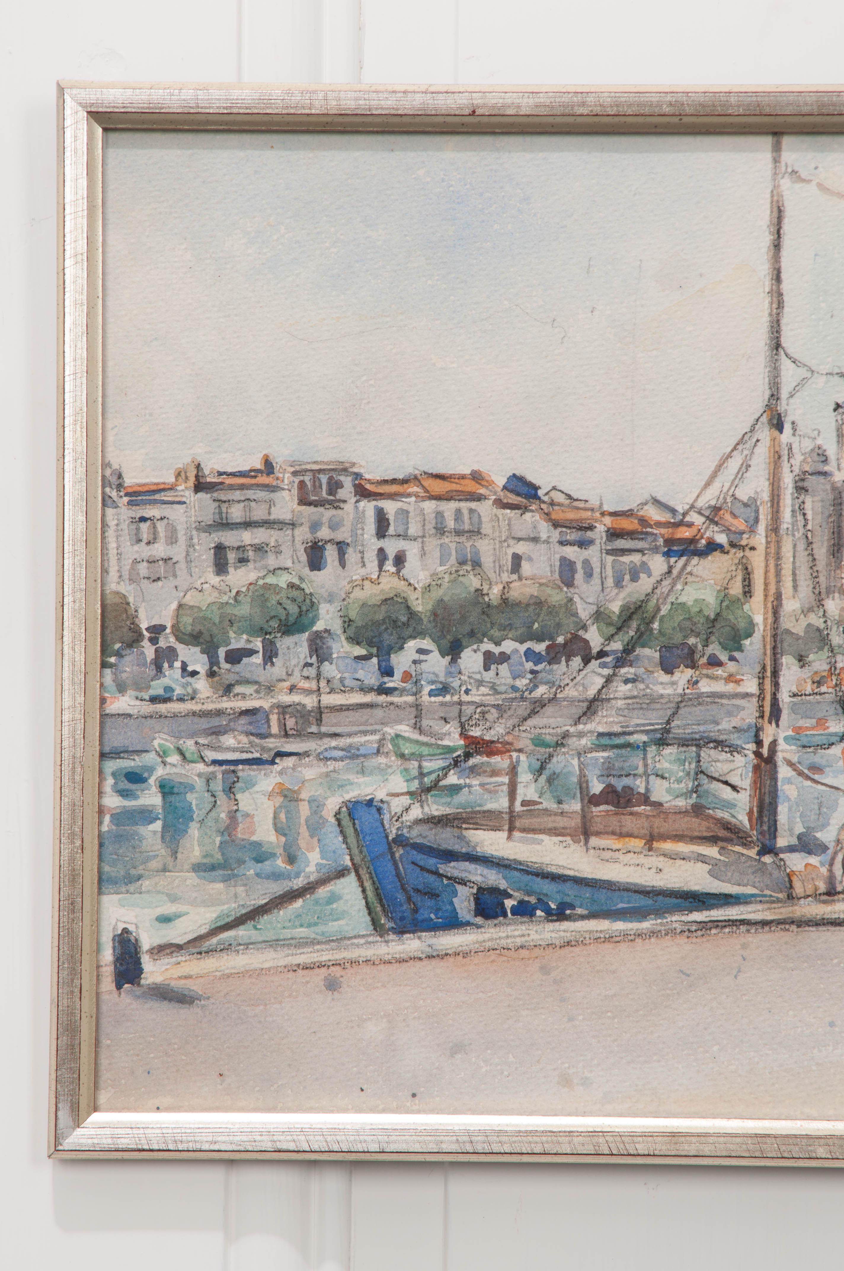 This charming watercolor on paper, circa 1940s, depicts two figures in a seaside village standing on a dock with a sailboat. Its size makes it perfect for a shelf or grouped on a wall with other small works of art.