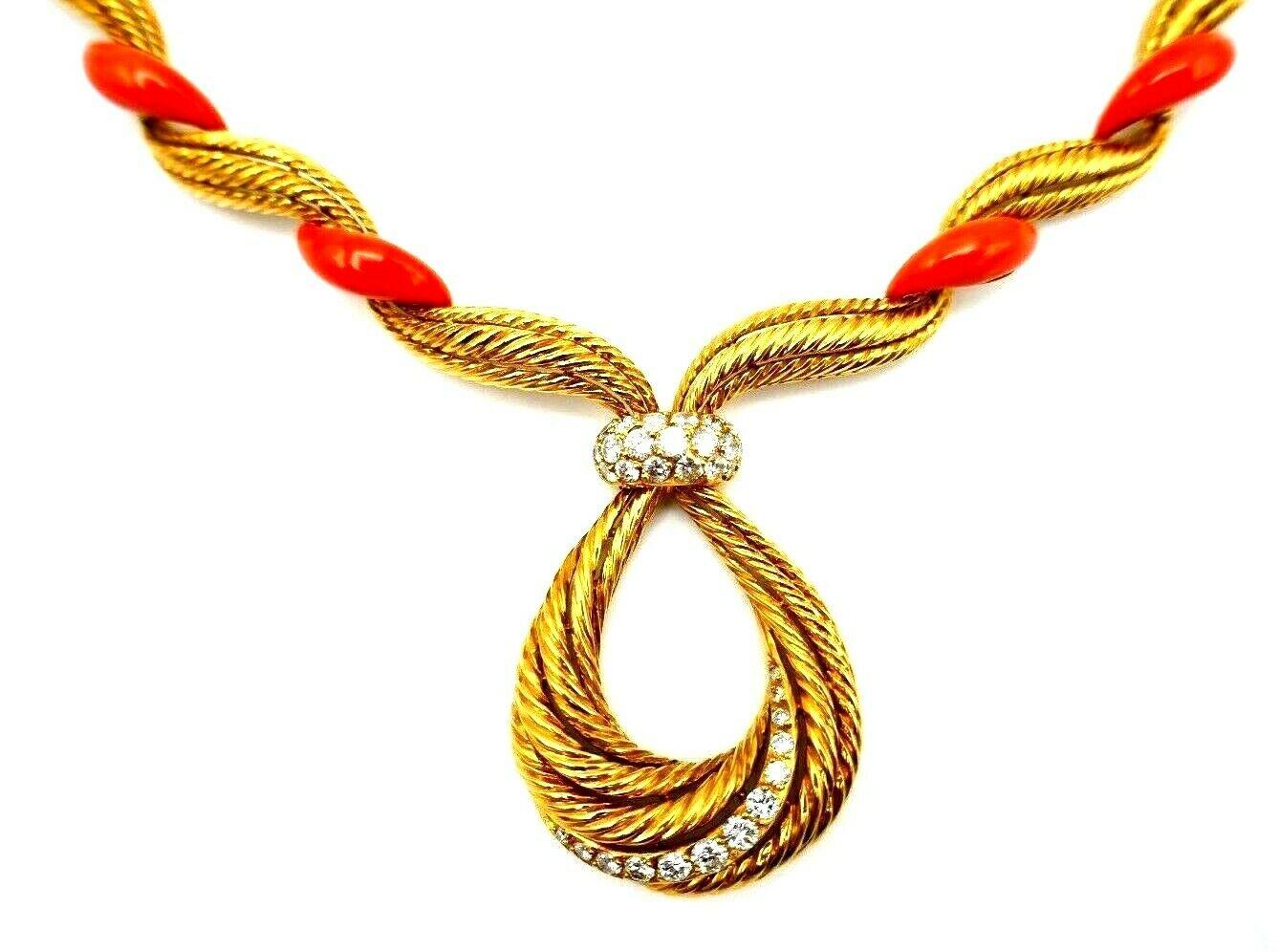 An exquisite vintage French necklace made of coral and 18k yellow gold featuring diamond. Swirling textured gold elements are connected with the beautiful coral parts. The drop is accented with round cut graduated diamonds. The diamond size varies