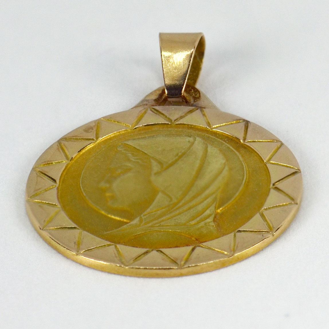 An 18 karat (18K) yellow gold charm pendant depicting the Virgin Mary. Stamped with the eagle’s head for French manufacture and 18 karat gold.

Dimensions: 1.8 x 1.2 x 0.1 cm (not including jump ring)
Weight: 1.67 grams 
