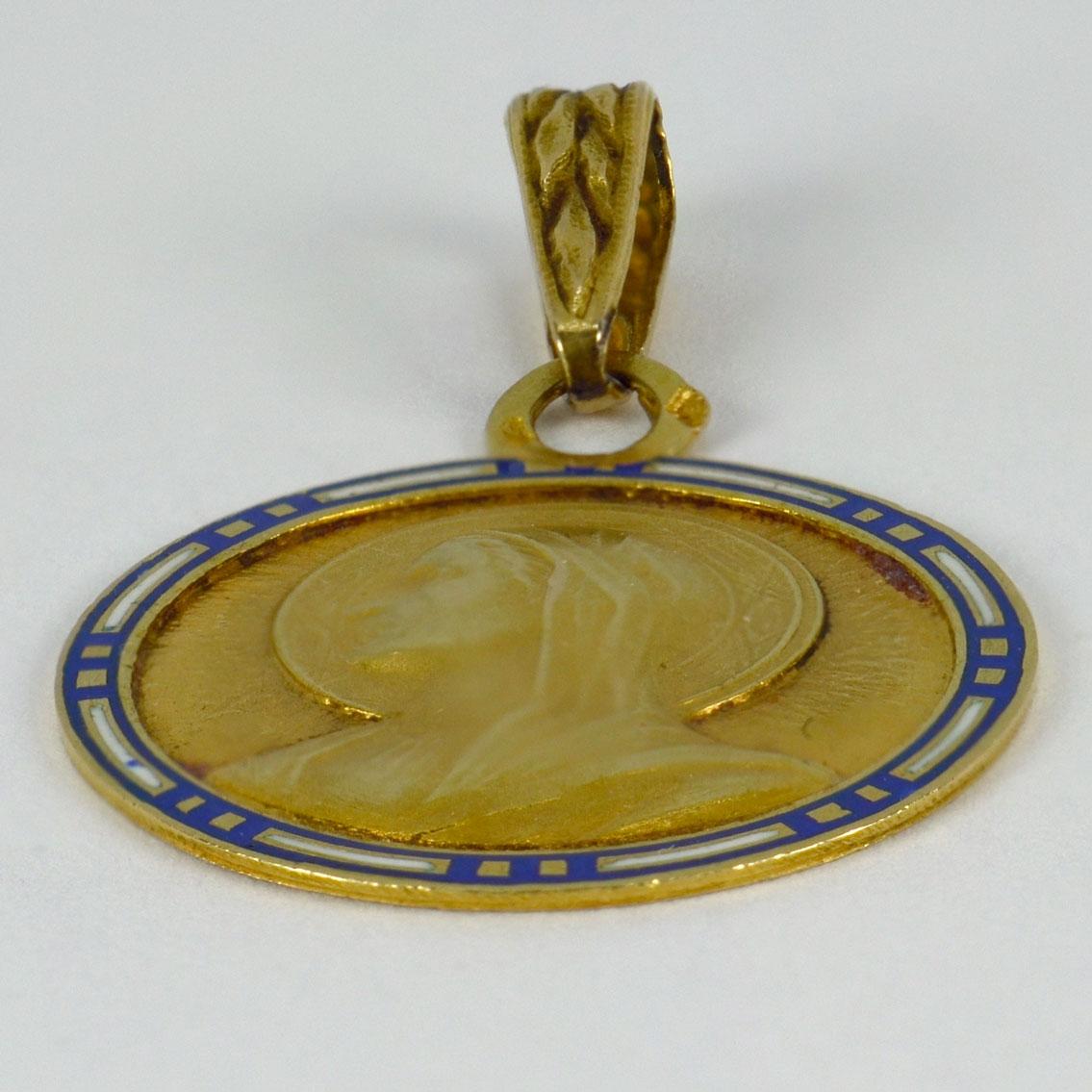 A French 18 karat (18K) yellow gold charm pendant designed as a medal depicting the Virgin Mary with a blue and white cloisonne enamel frame, with a monogram for SP and the date ‘19 Juin 1930’ to the reverse. Stamped with the eagle’s head for French