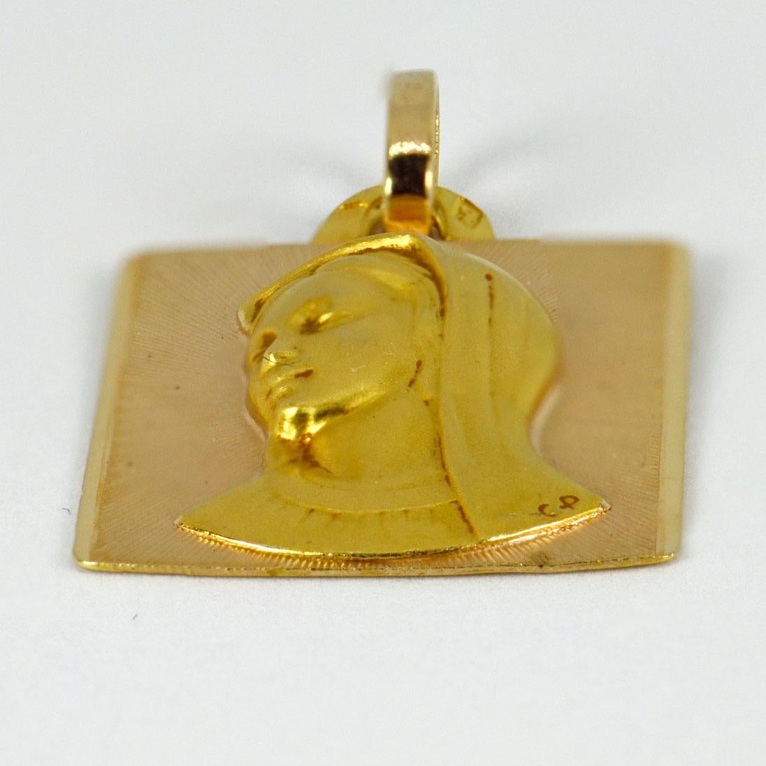 An 18 karat (18K) yellow gold pendant designed as a rectangular medal depicting the Virgin Mary. Signed C.P. Stamped with the eagle’s head for French manufacture and 18 karat gold, with unknown maker’s mark.

Dimensions: 2.5 x 1.8 x 0.35 cm (not