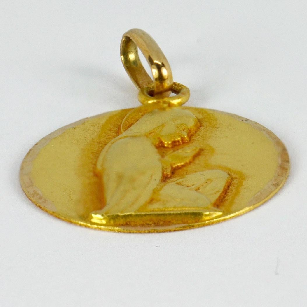An 18 karat (18K) yellow gold pendant designed as a round medal depicting the Virgin Mary. Signed Sannera. Stamped with the eagle’s head for French manufacture and 18 karat gold, with maker’s mark for Sonne.

Dimensions: 2.2 x 1.8 x 0.13 cm (not