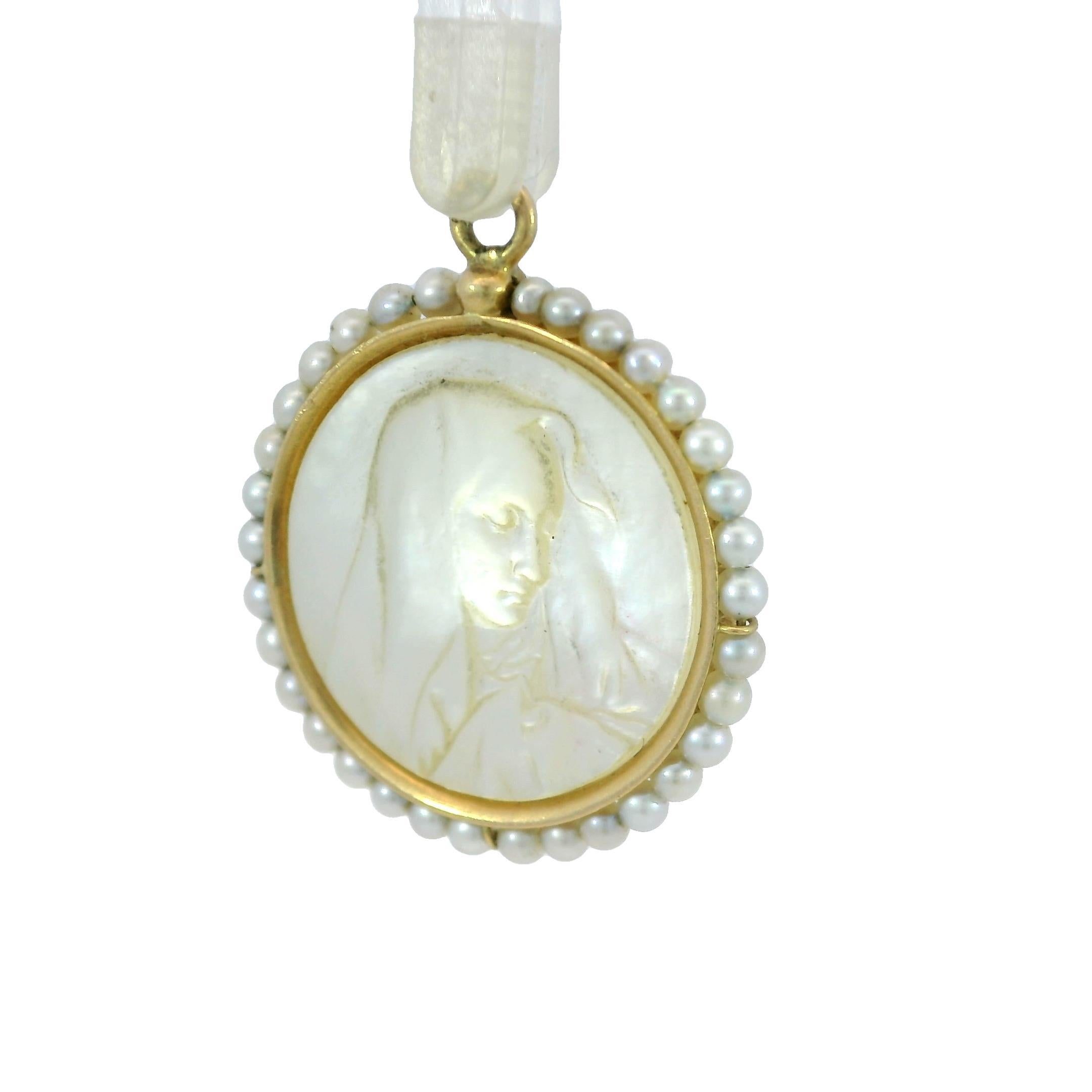 French Virgin Mary Charm Carved Mother of Pearl 18K Yellow Gold Pearl Frame

This vintage charm pendant in 18k yellow gold features a delicate figure carved into mother of pearl, possibly representing the Blessed Mother Mary. While the exact