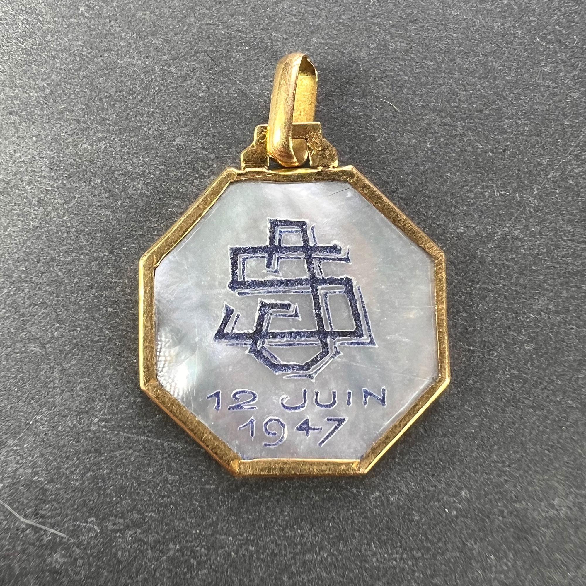 An 18 karat (18K) yellow gold charm pendant set with mother of pearl depicting the Virgin Mary. Engraved to the reverse with a monogram for SJ and the date 12 Juin 1947. Stamped with the eagle mark for 18 karat gold and French manufacture with