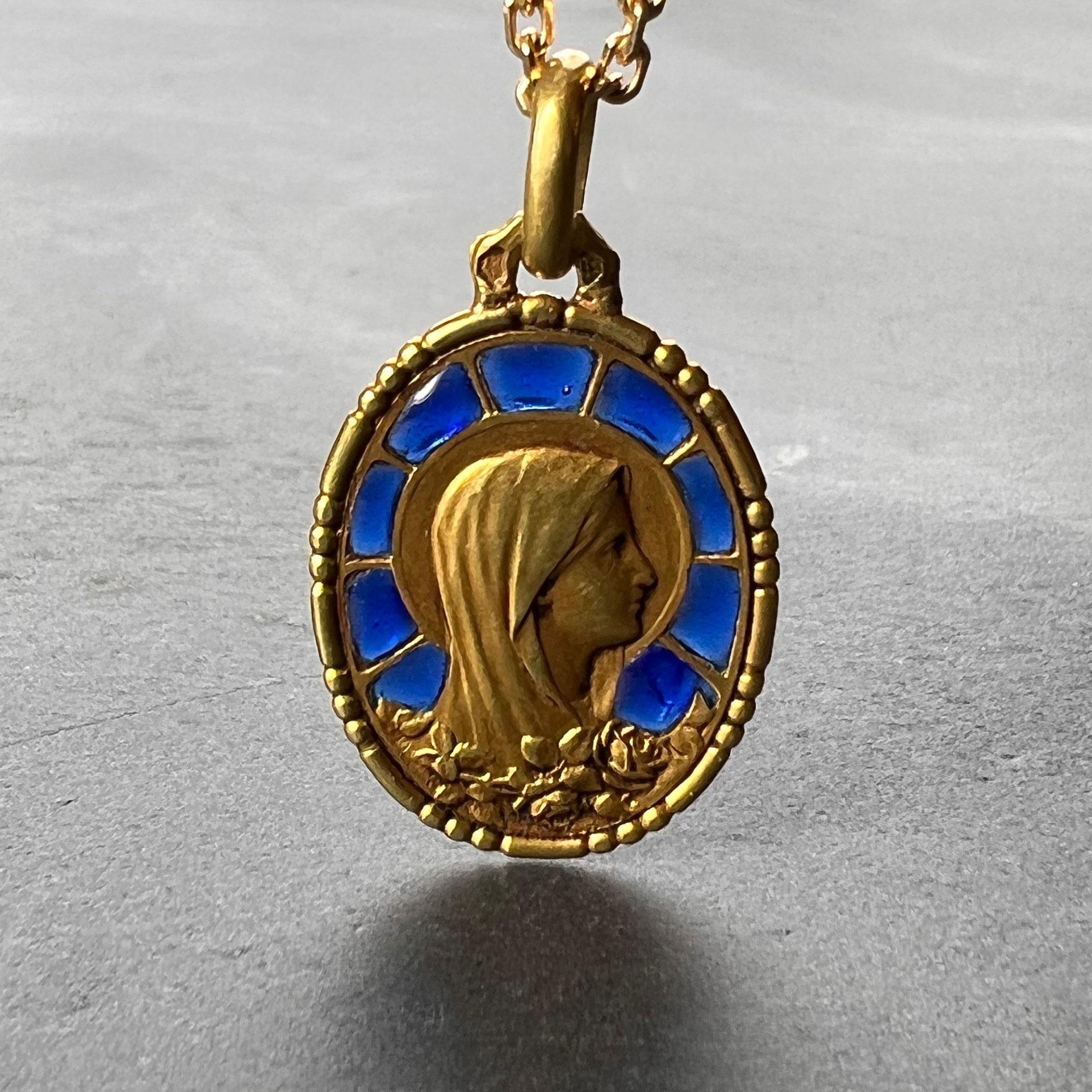 An 18 karat (18K) yellow gold charm pendant set with plique a jour blue enamel designed as the Virgin Mary with a motif of roses. Engraved with a monogram for SJ and the date 31-12-1935. Stamped with the eagle mark for 18 karat gold and French