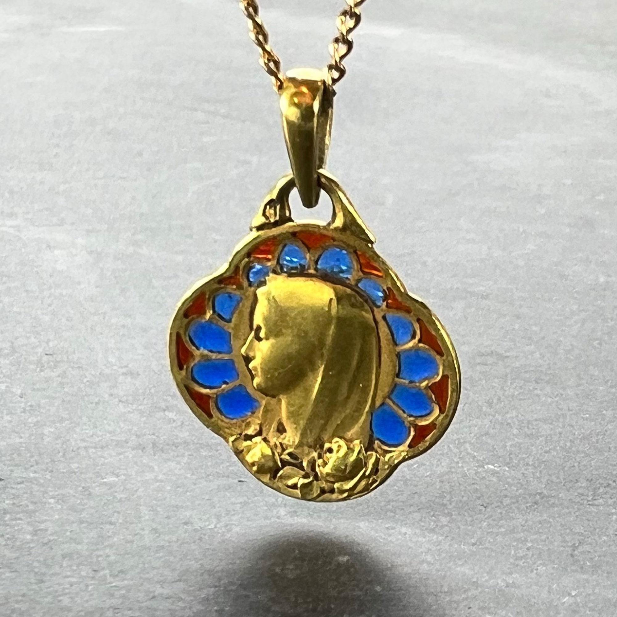 A French 18 karat (18K) yellow gold charm pendant with quatrefoil outline, set with plique a jour blue and red enamel designed as the Virgin Mary with a motif of roses. The reverse engraved with a monogram for AJ and the date 19 Juin 1932. Stamped
