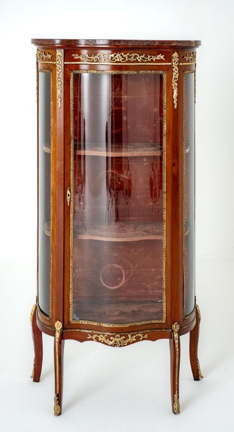 French Mahogany Vitrine.
Circa 1900
This Piece is Raised upon Shaped Legs.
The Cabinet is of a Serpentine Form with a Glazed Central Door and Glazed Side Panels.
The Cabinet is Adorned with Ormolu Mounts and Moldings.
Comes Complete with a Marble