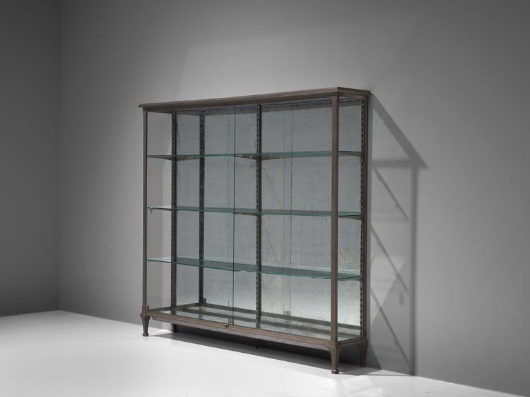 Large vitrine, glass, metal, mirrored glass, France, 1950s

This outstanding vitrine has an utterly well-balanced construction concealing a great sense of proportions. The front and sides are executed in glass which allows the user to display its