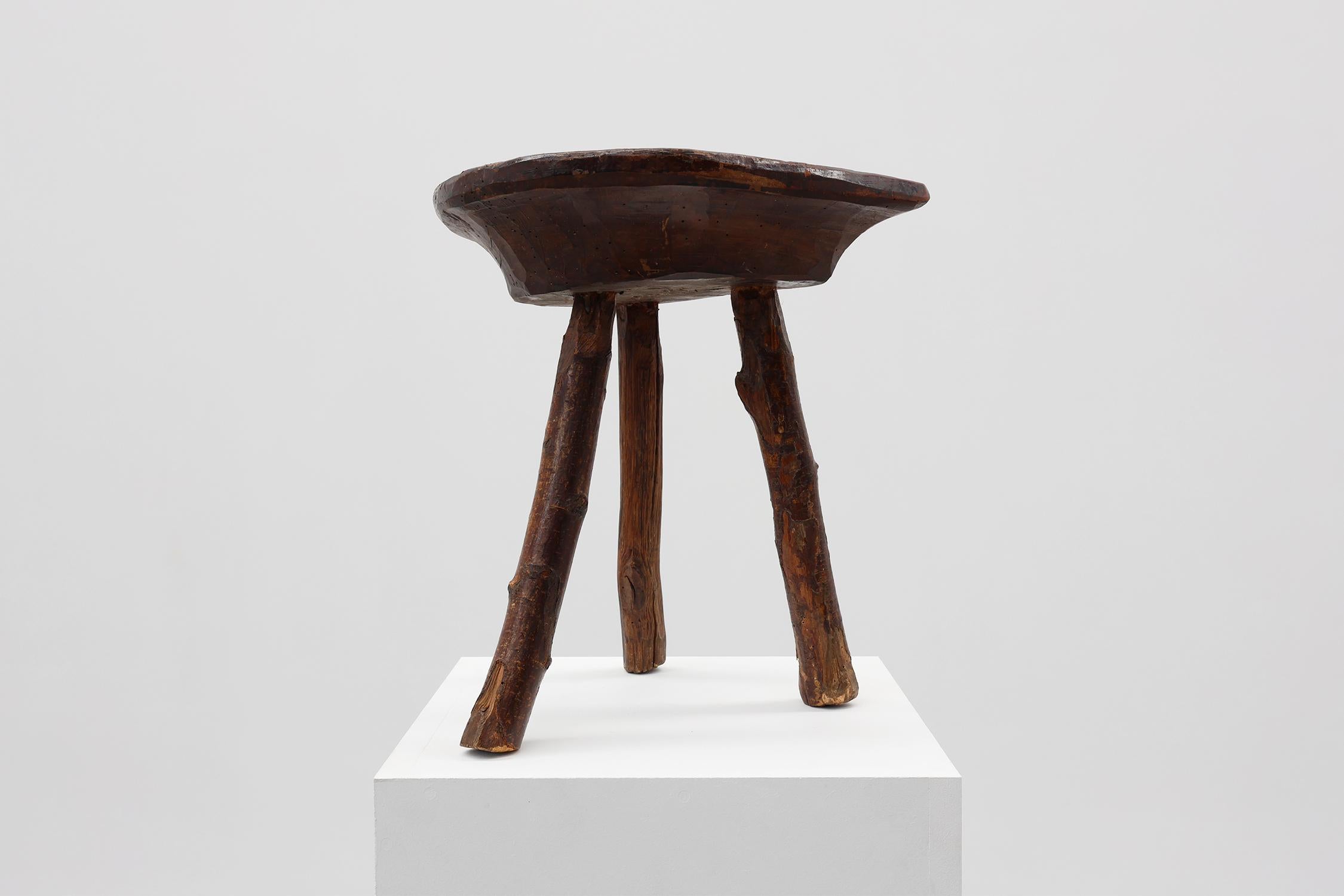 Brutalist French wabi sabi low tripod stool in solid wood, 1850s For Sale