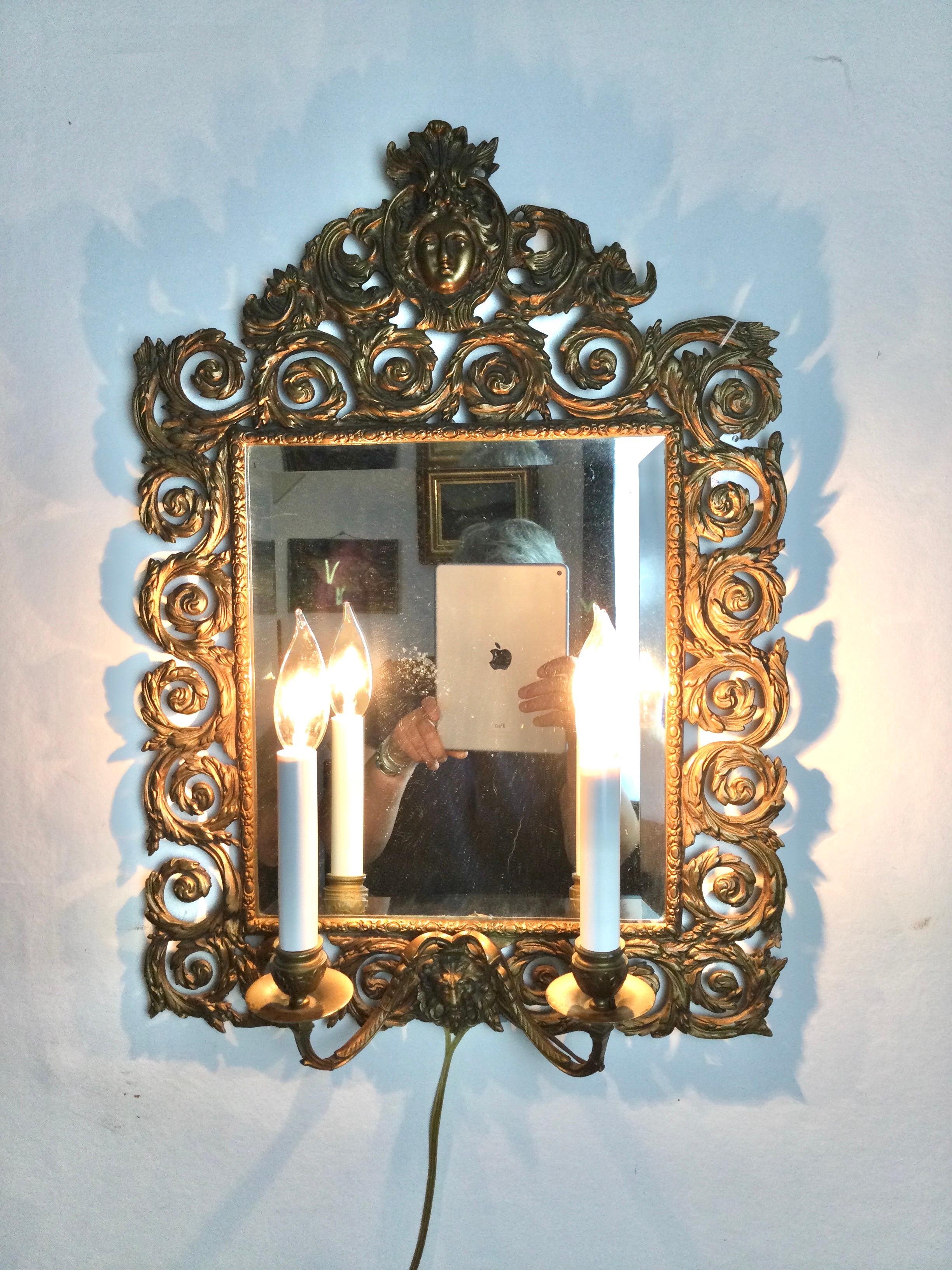 French wall mirror brass double light scones. In the style of Louis XV. Wires are new. You can hard wire to the wall or use as I have with cord. 22