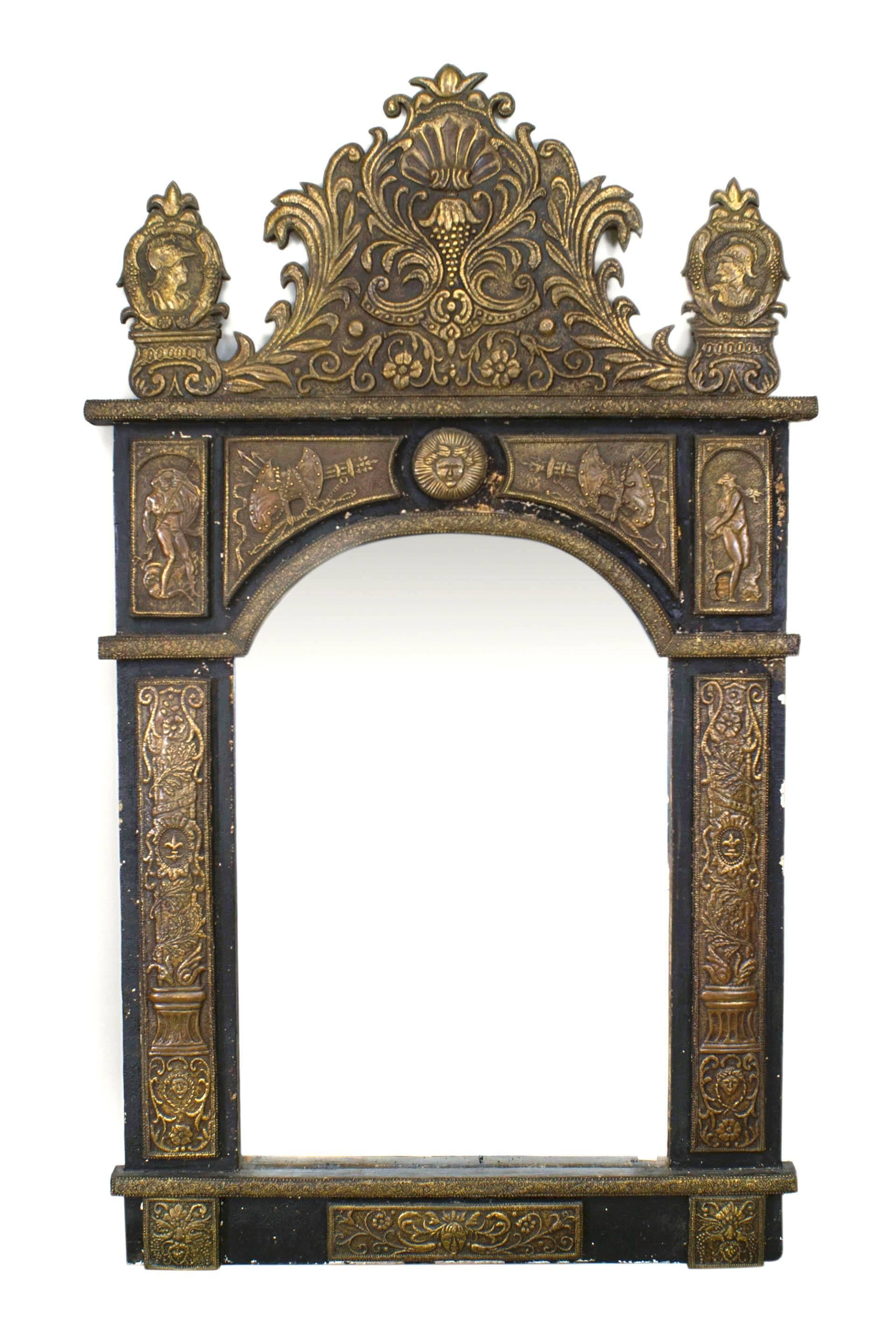 French Renaissance-style (19th Century) brass embossed repose wall mirror in an ebonized frame with Renaissance-style figures and motifs, an arch form mirror, and a pediment top.
