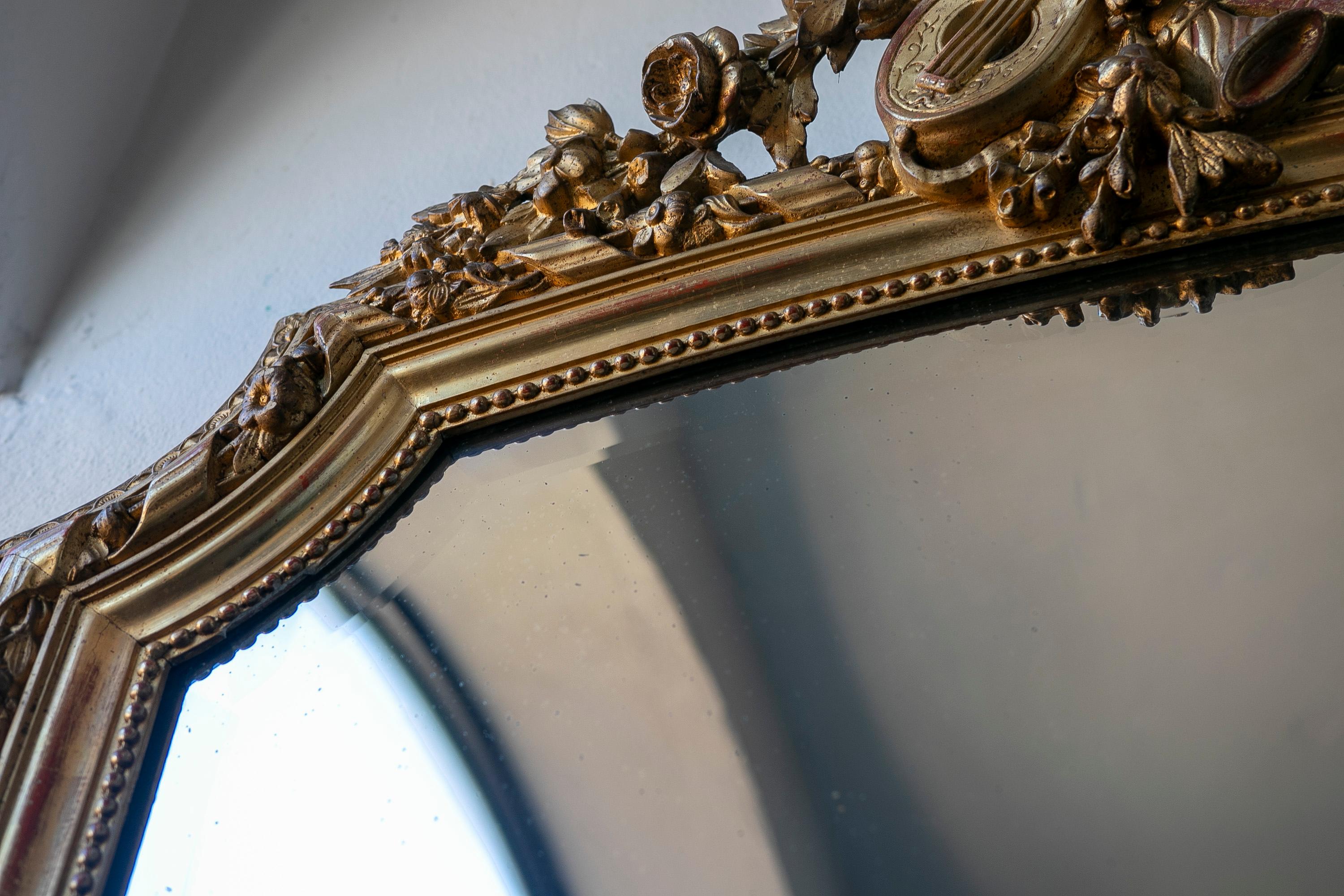 French Wall Mirror in Gilded Wood with the Coping Top Decorated with Instruments For Sale 6