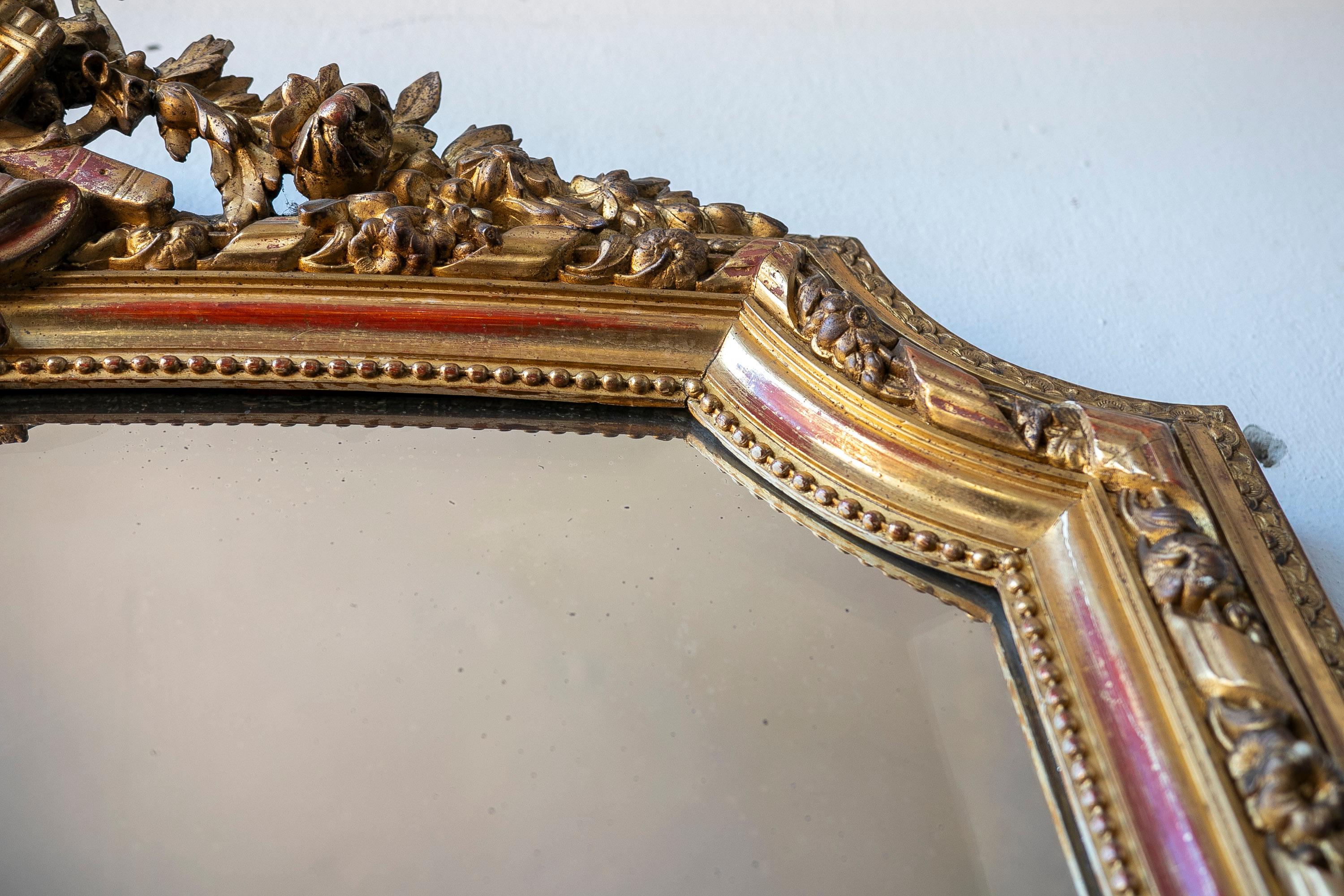 French Wall Mirror in Gilded Wood with the Coping Top Decorated with Instruments For Sale 7