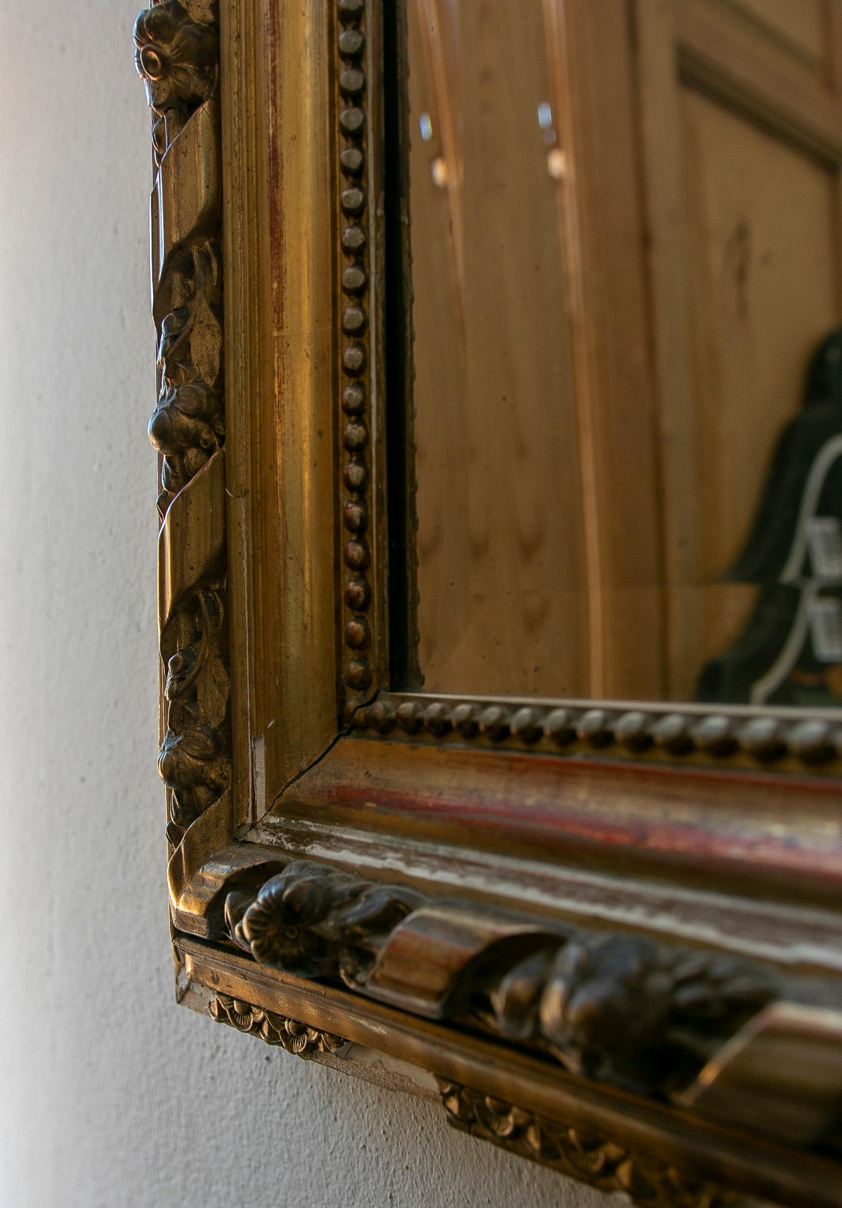 19th Century French Wall Mirror in Gilded Wood with the Coping Top Decorated with Instruments For Sale