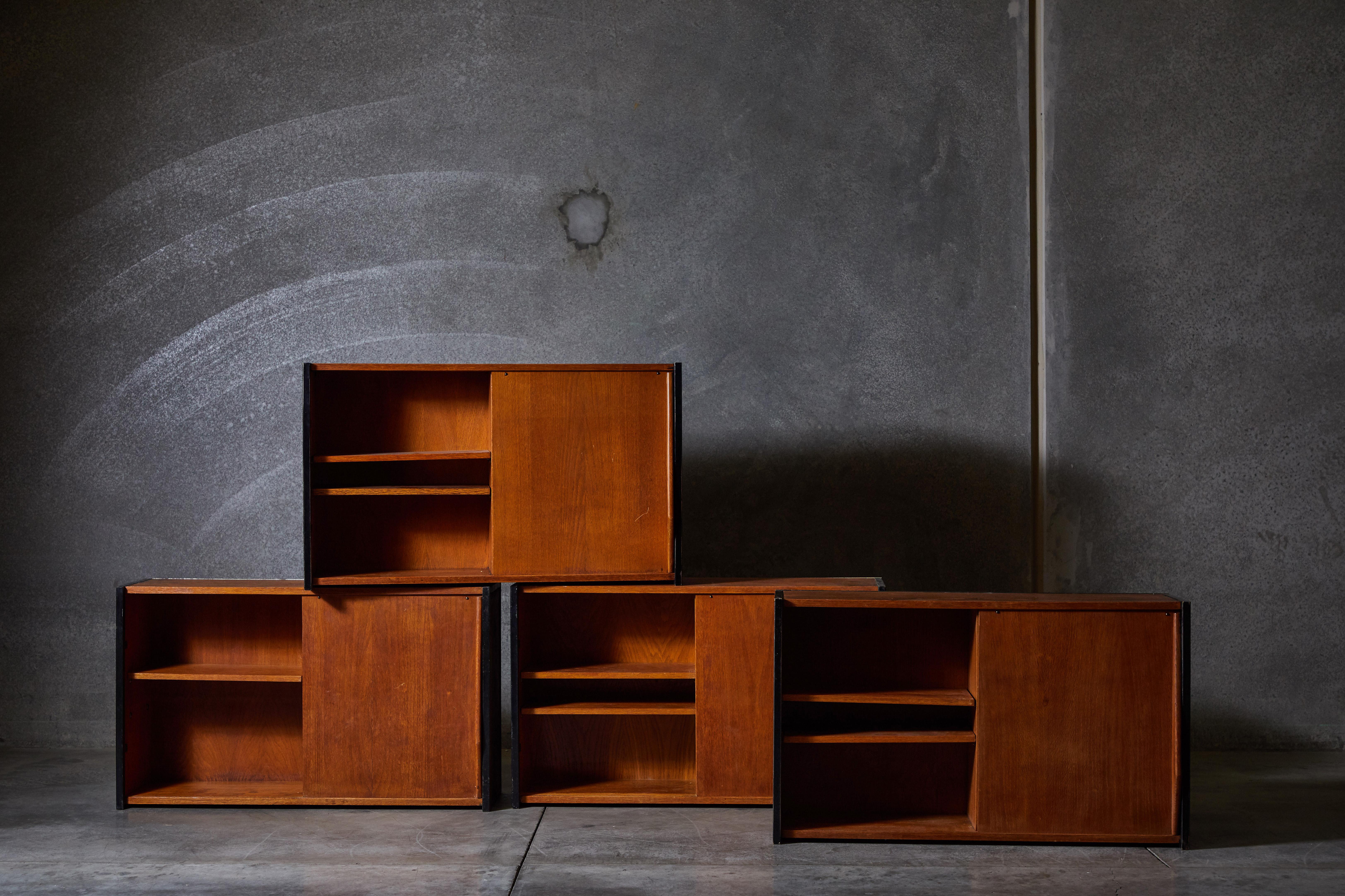 French wall mounted cabinets with single sliding door in the style of Charlotte Perriand. Made in France, circa 1950s.