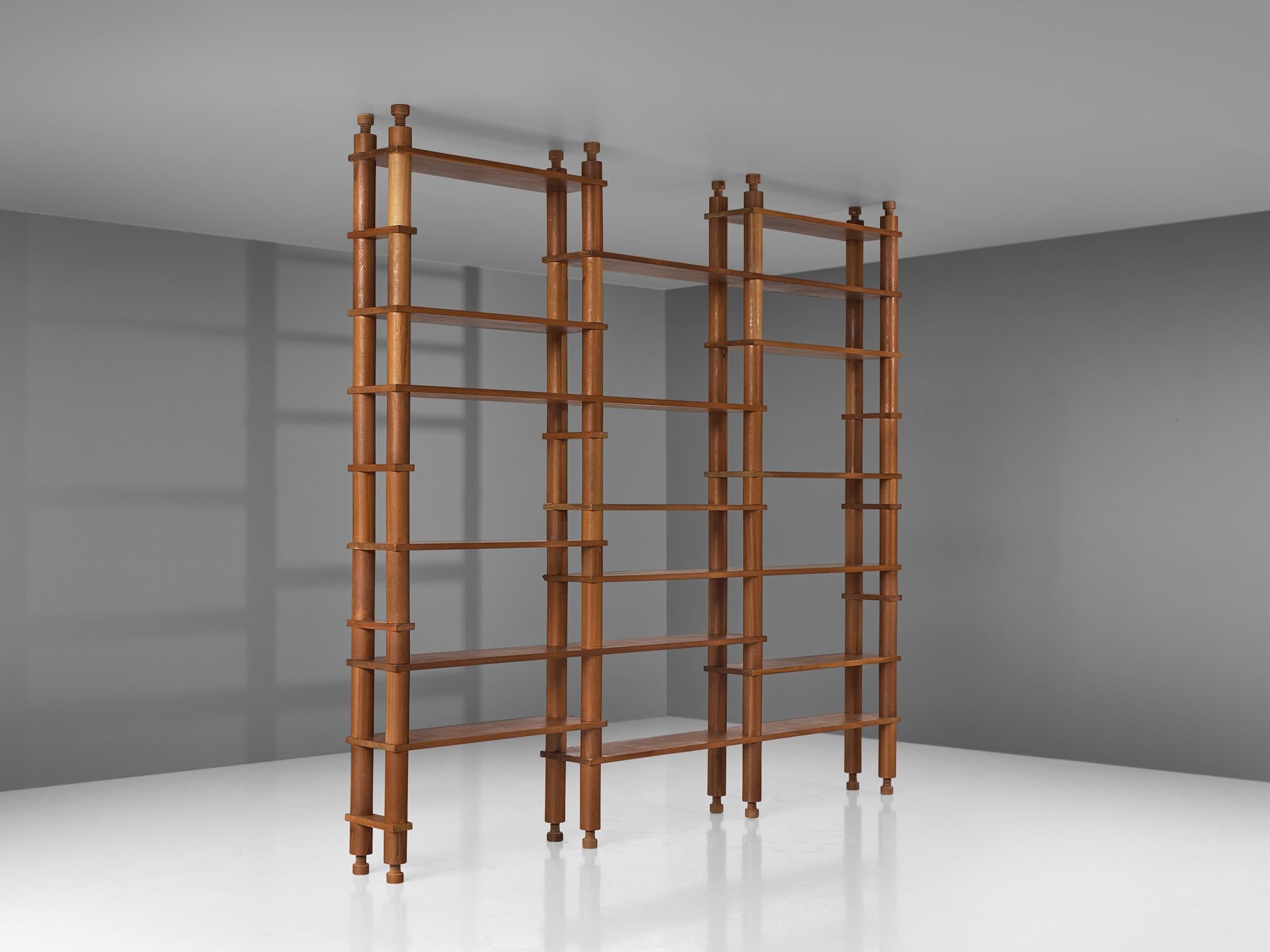 Wall unit, mahogany, France, 1960s

A large French shelving system which is completely executed in mahogany wood. The freestanding cabinet is build up with wooden cylindrical tubes. Each point of connection holds a bookshelf, creating a playful