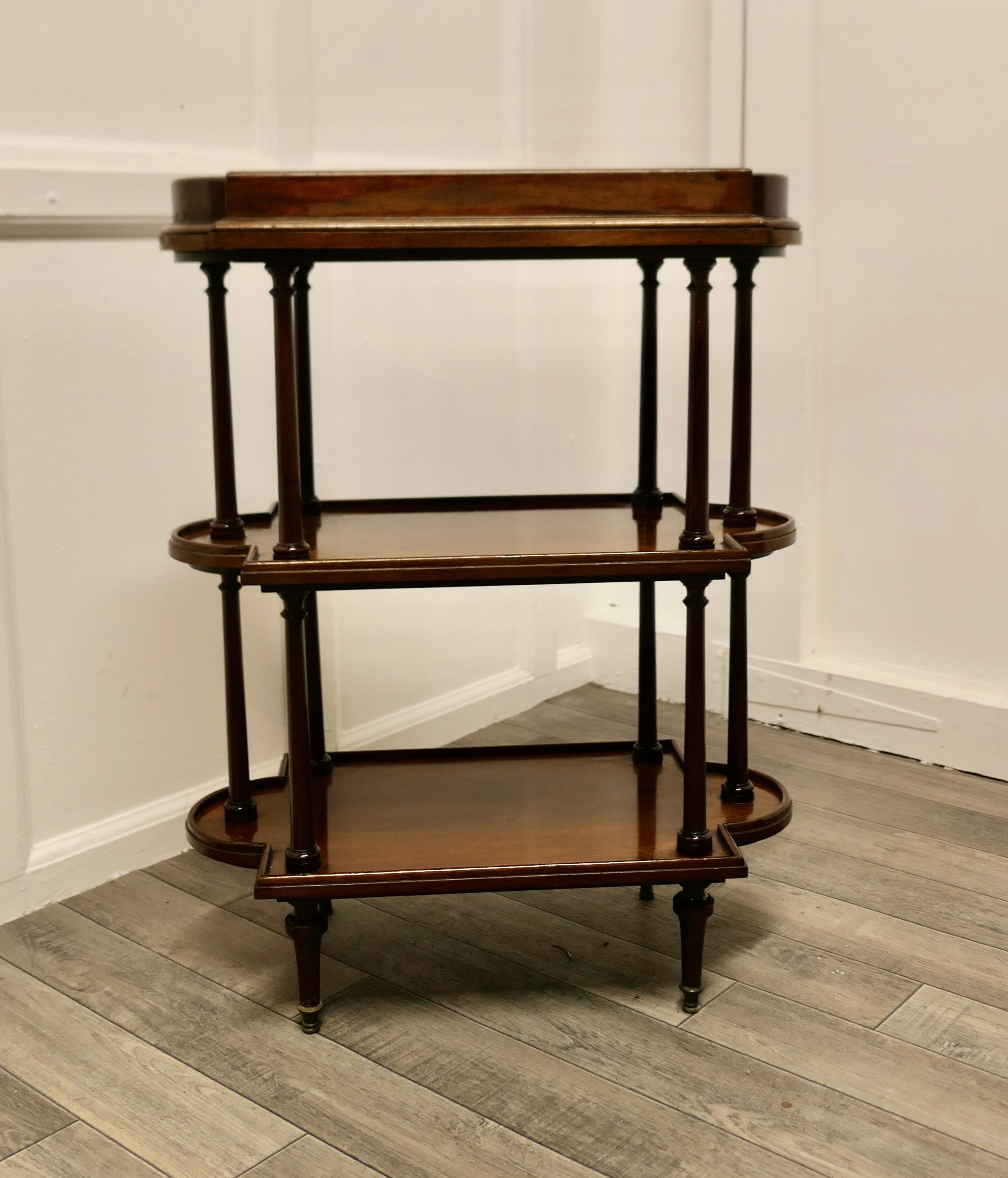 French Walnut 3 Tier Etagere or Occasional table

This useful little stand has three tiers, and a very unusual shape, the top shelf has a raised gallery edge, below this there two more similar shaped tiers and turned legs at the bottom 
This is