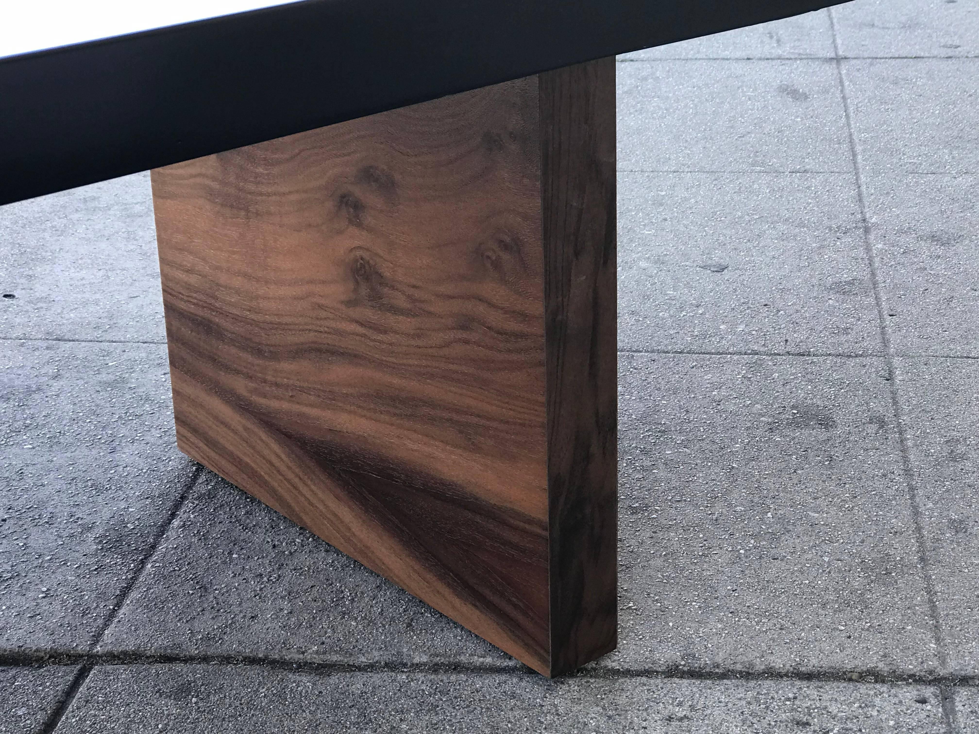 Solid walnut base with a black lacquered top for this very unusual shape coffee table. Made in France by an unknown maker.