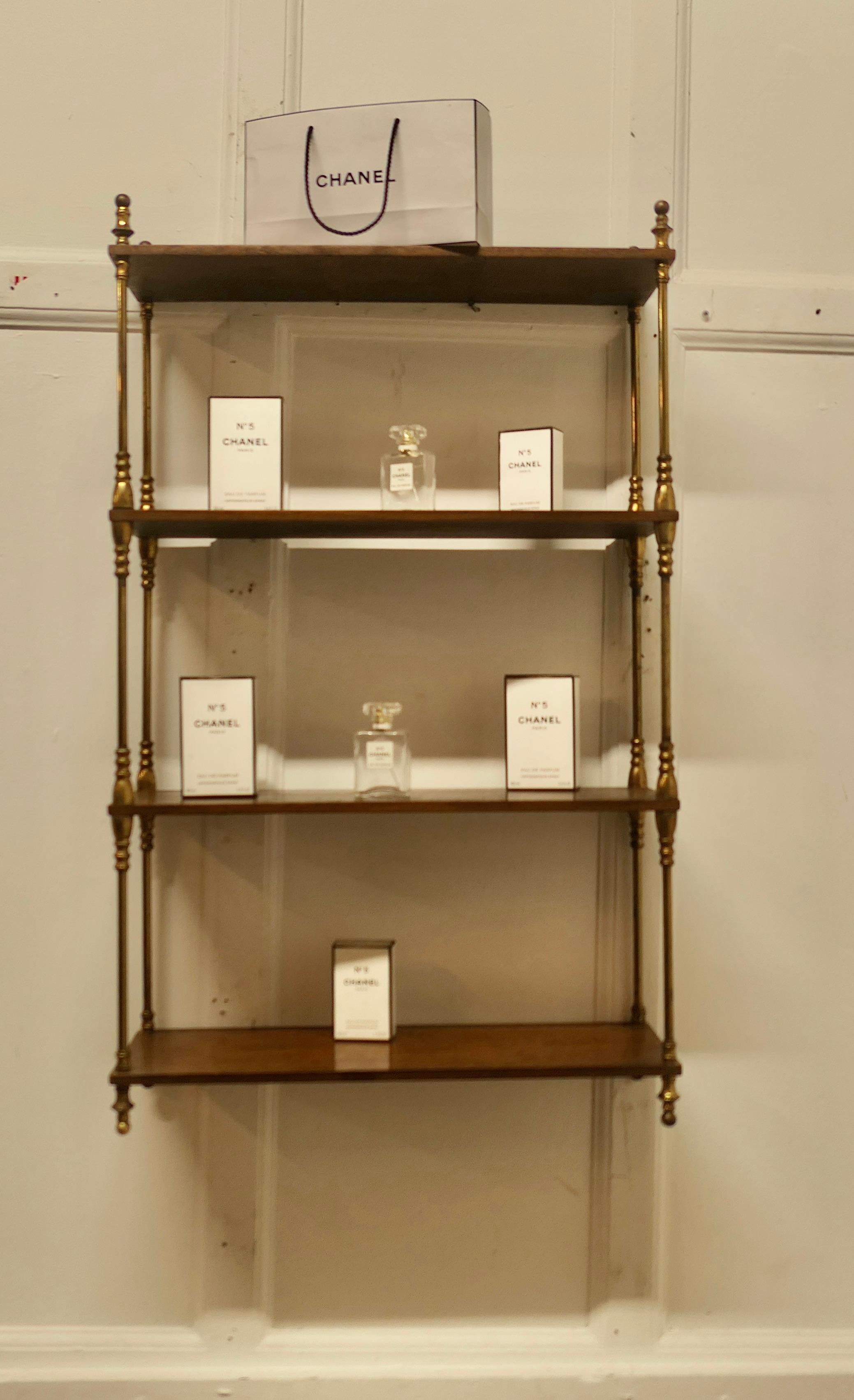 French Walnut and Brass Open Shelf  Unit

The shelf or étagère is fixed to the wall, it has 4 open shelves connected with turned brass upright columns
The shelf is 36” high overall, 22” wide and 8” deep
TZX453