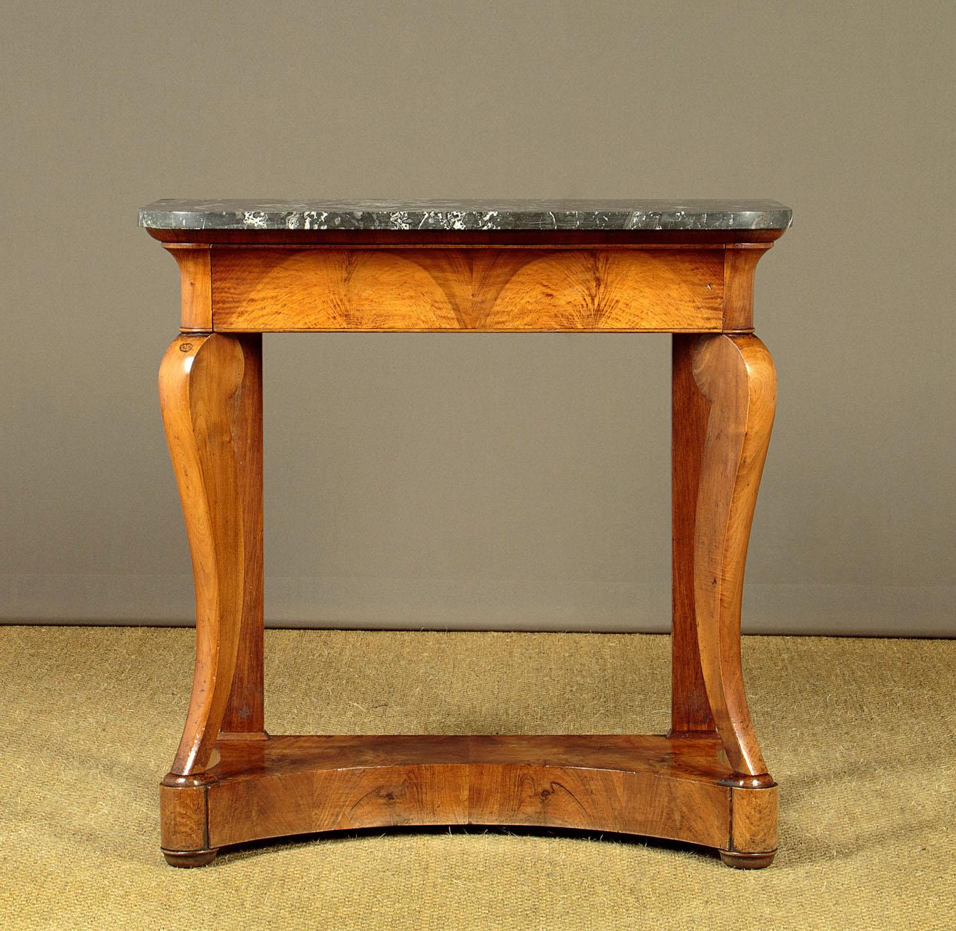 This elegant console table dates back to around 1830 and features a smart French walnut design with a gorgeous grey marble top. The subtly rounded corners of the marble top add a touch of sophistication. The frieze of the table is uniquely designed