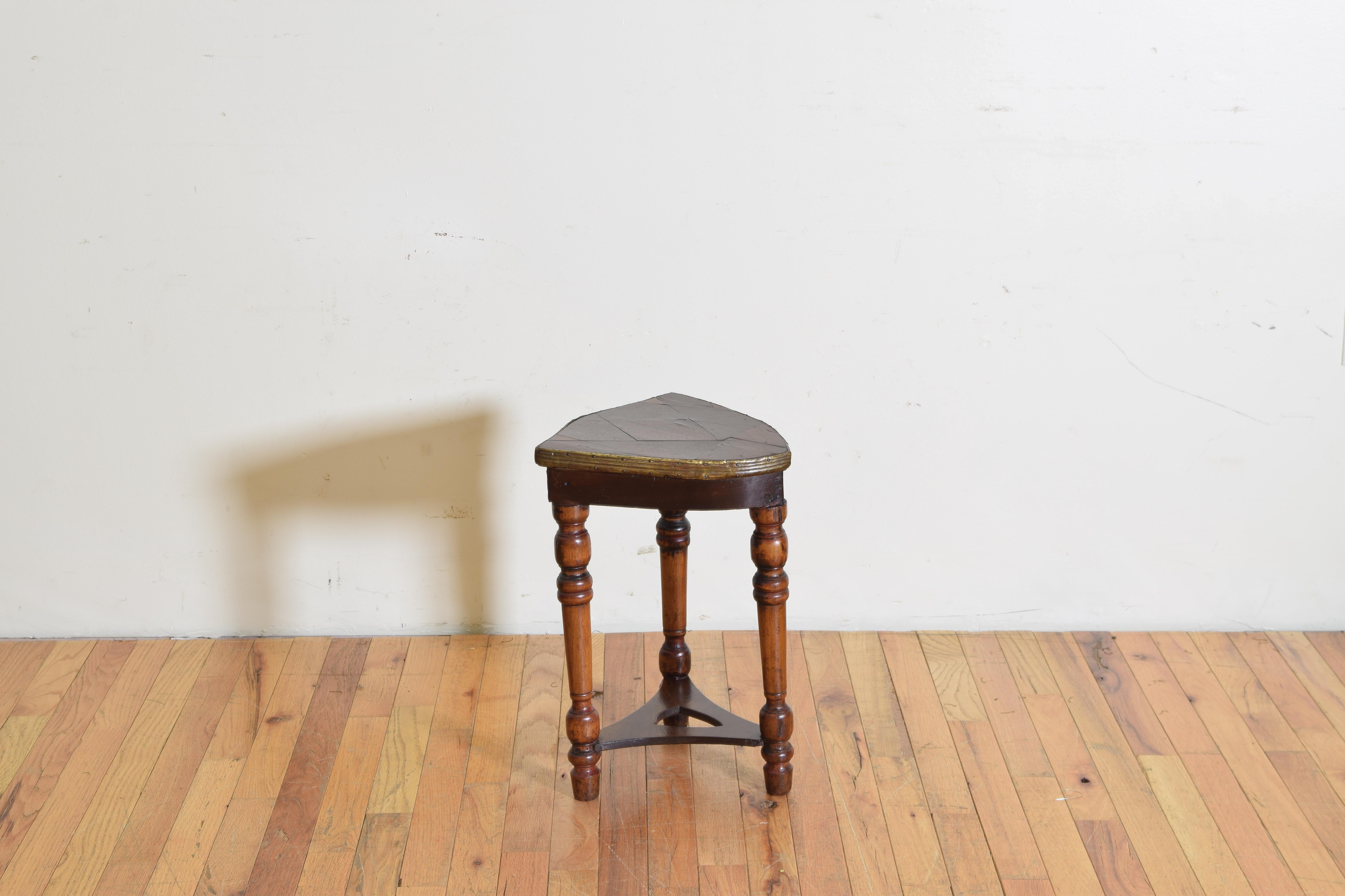 Having a brass-mounted shield form parquetry top atop turned legs joined by a shaped stretcher with cutout shield-form, and having an unusual hidden round storage area on the underside accessible by three screws.