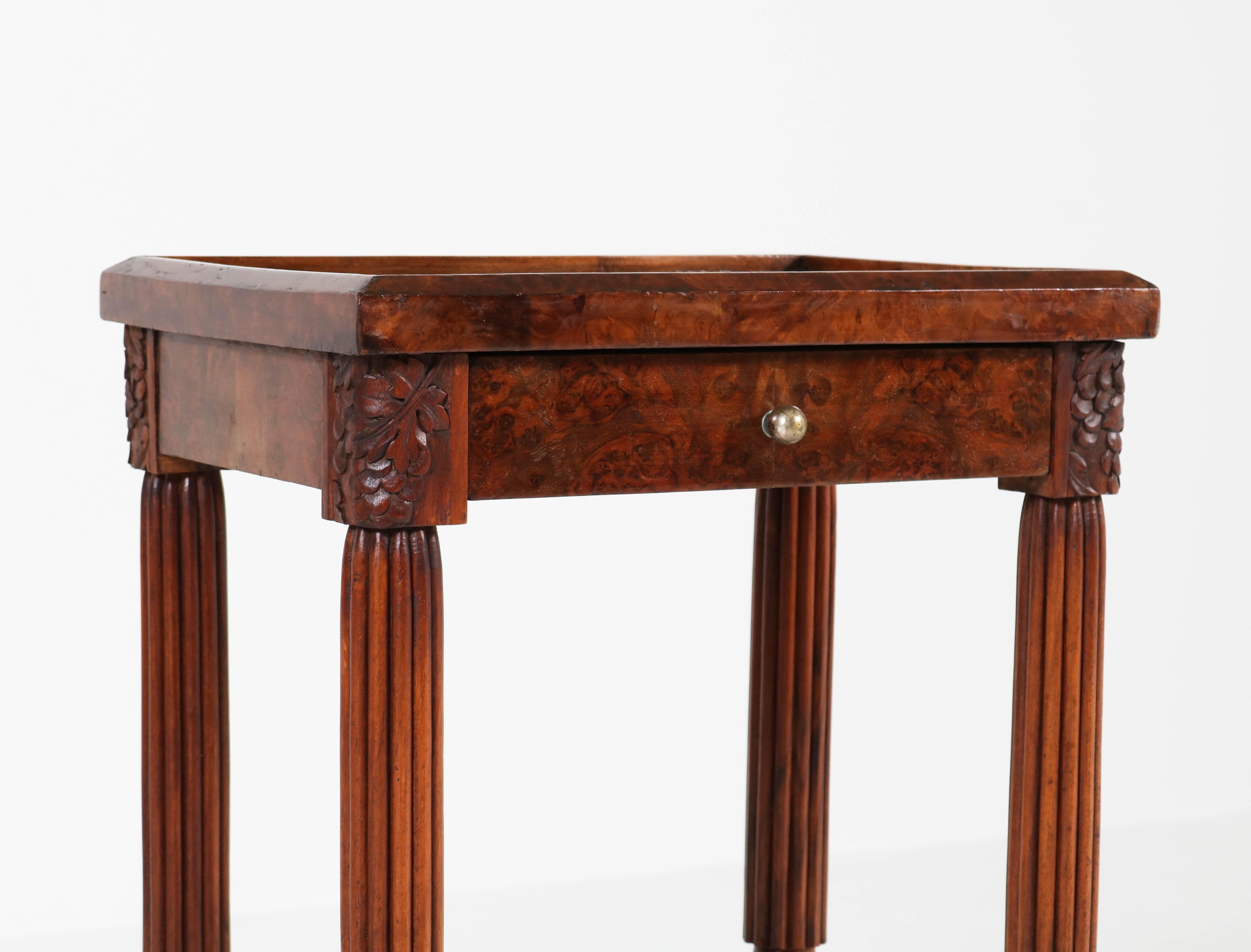 Offered by Amsterdam Modernism:
Stunning and elegant walnut Art Deco side table with drawer.
Striking French design from the 1920s.
In good original condition with minor wear consistent with age and use,
preserving a beautiful patina.
 