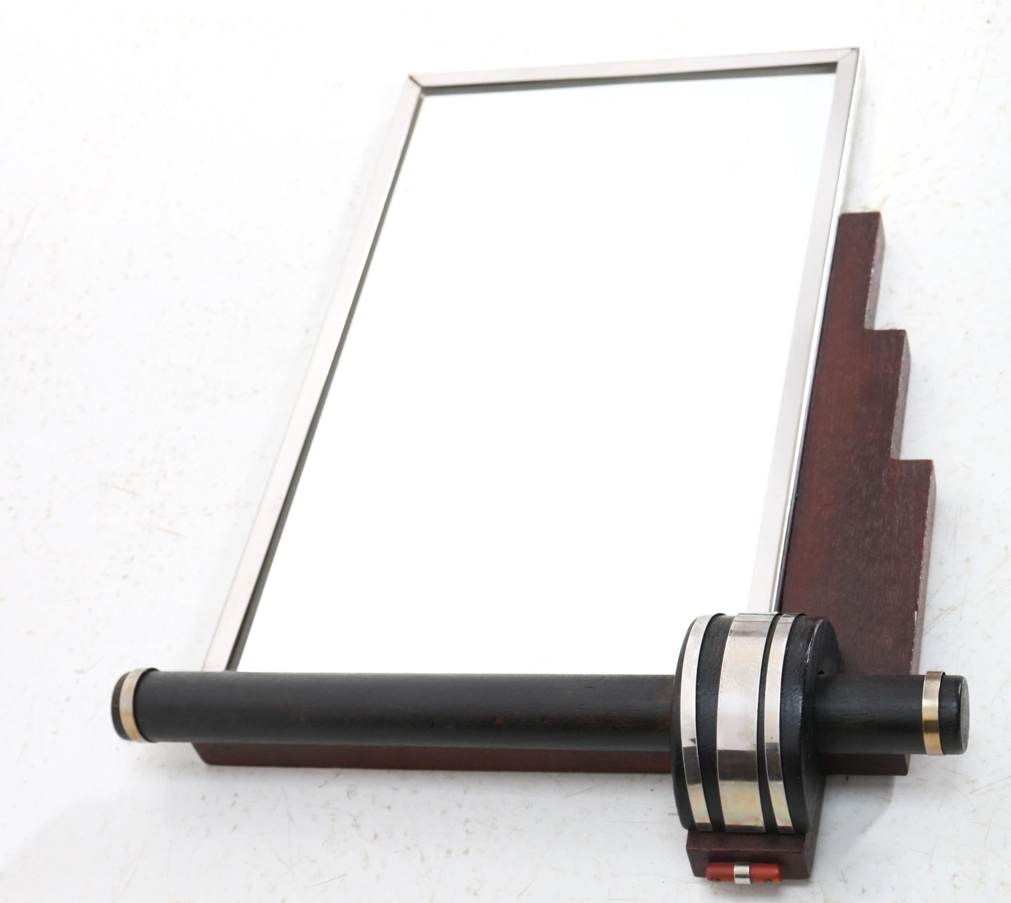 Stunning and elegant Art Deco petite wall mirror.
Striking French design from the 1930s.
Original walnut and nickel-plated brass frame with original black
lacquered lining.
The mirror is also original.
This wonderful Art Deco petite wall mirror is