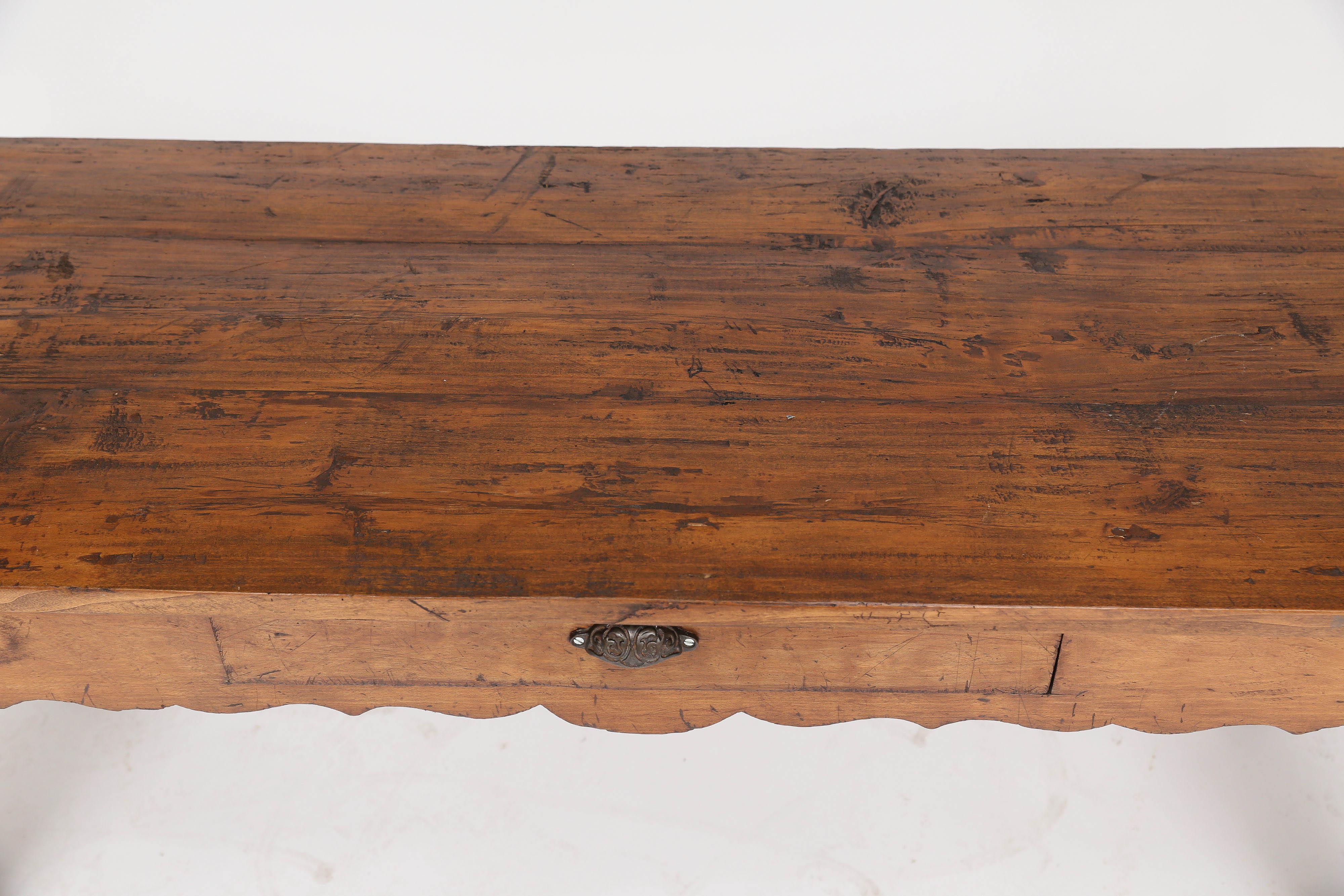 Fabulous French walnut butcher table, late 19th century. Presented as found, without the butcher block top, this piece would make a great entry table below a large mirror or coffee table. The sturdy construction, detailed apron on four sides and one