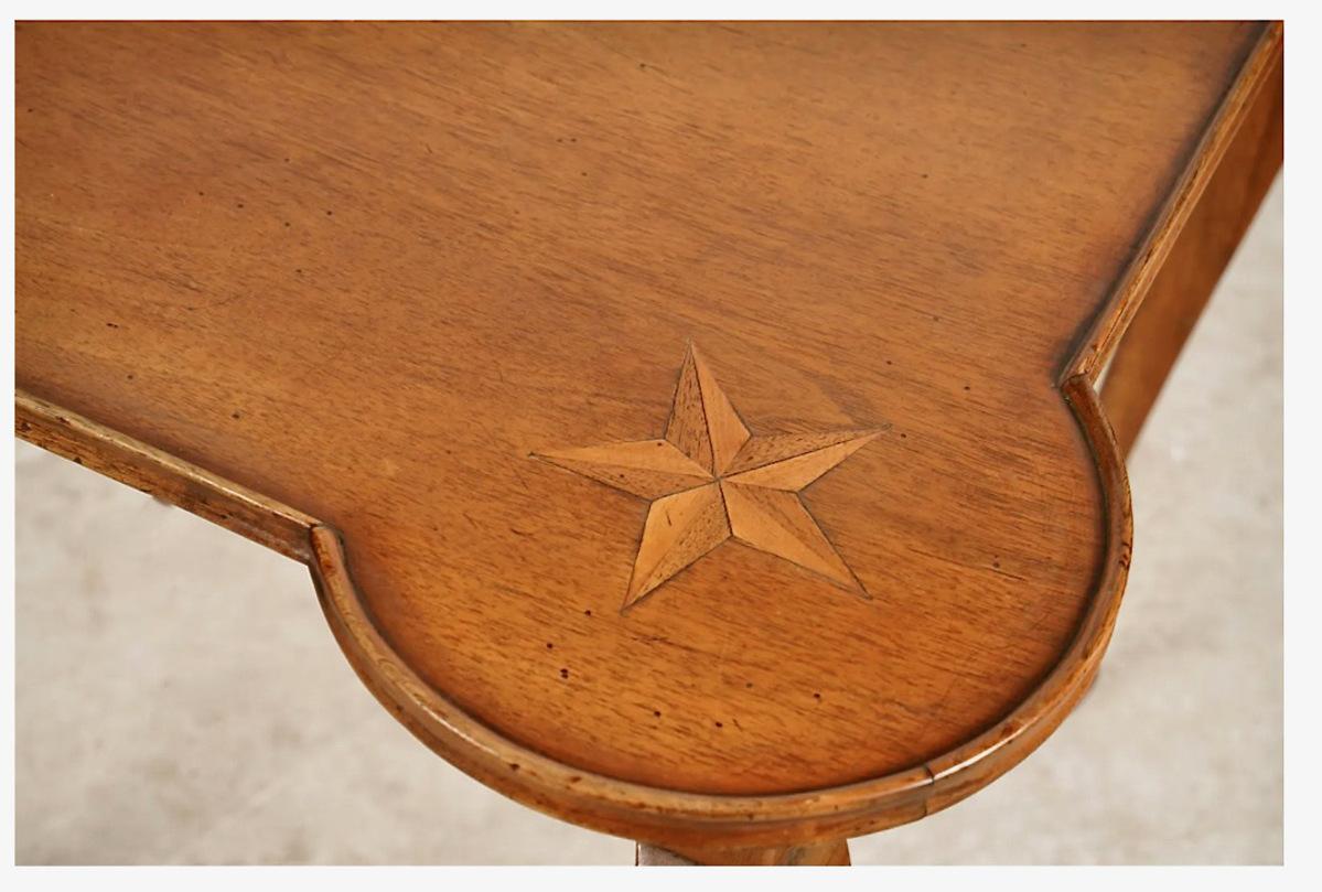 This is a charming French Provincial Walnut games table that dates to the mid-20th century. The top features a small lip surround, outset corners and a star inlays to each corner. The elegant legs are in the Louis XV cabriolet style. The table is in