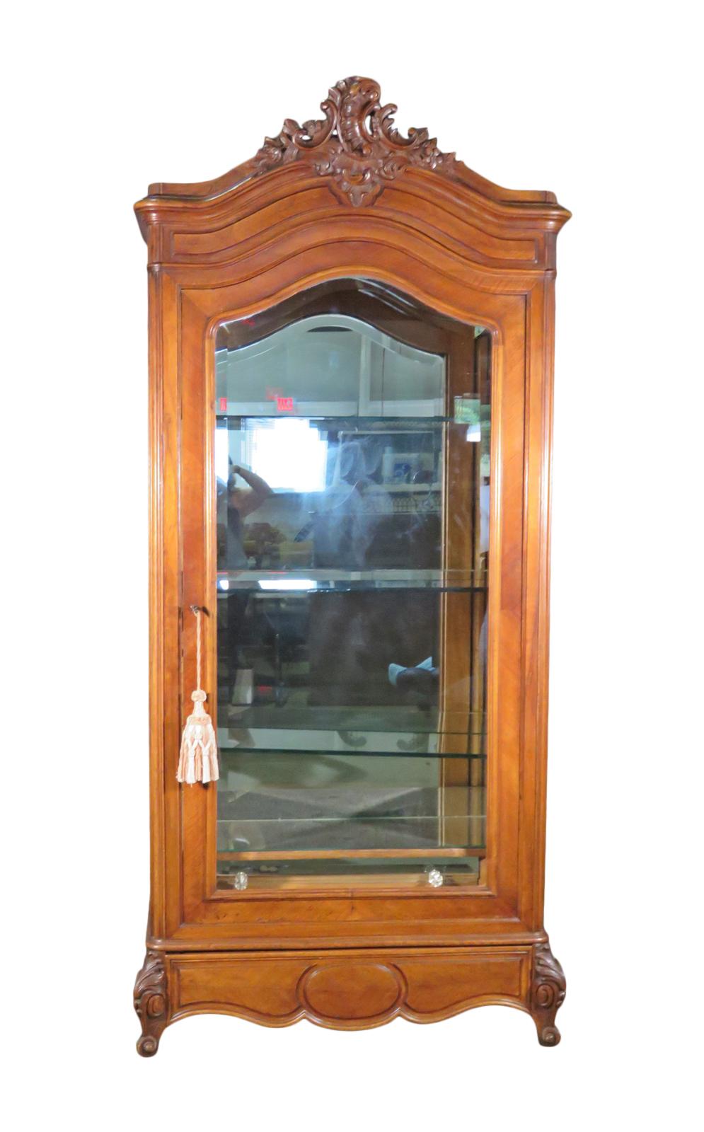 Wood frame. Beveled glass door. Mirrored back, bottom shelf and drawer front. 3 glass shelves.1 dovetailed drawer. Lighted. Carved. Measures: 92 1/2