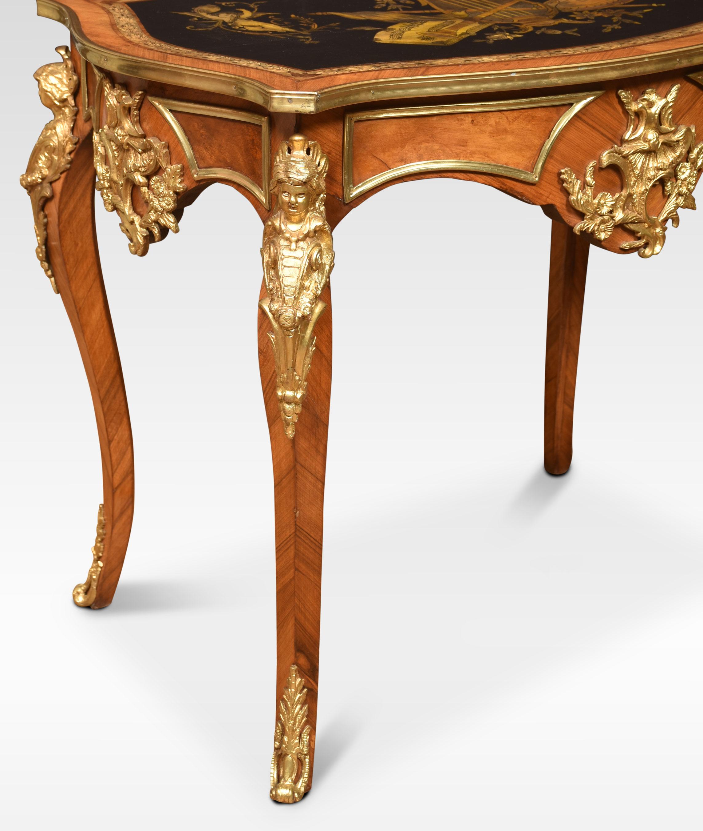 French walnut centre table of cartouche outline, the ebonised top inlaid with musical instruments and garlands flanked by cherubs and birds, with decorative gilt metal mounts to the apron. All raised up on four cabriole legs.
Dimensions
Height 30.5