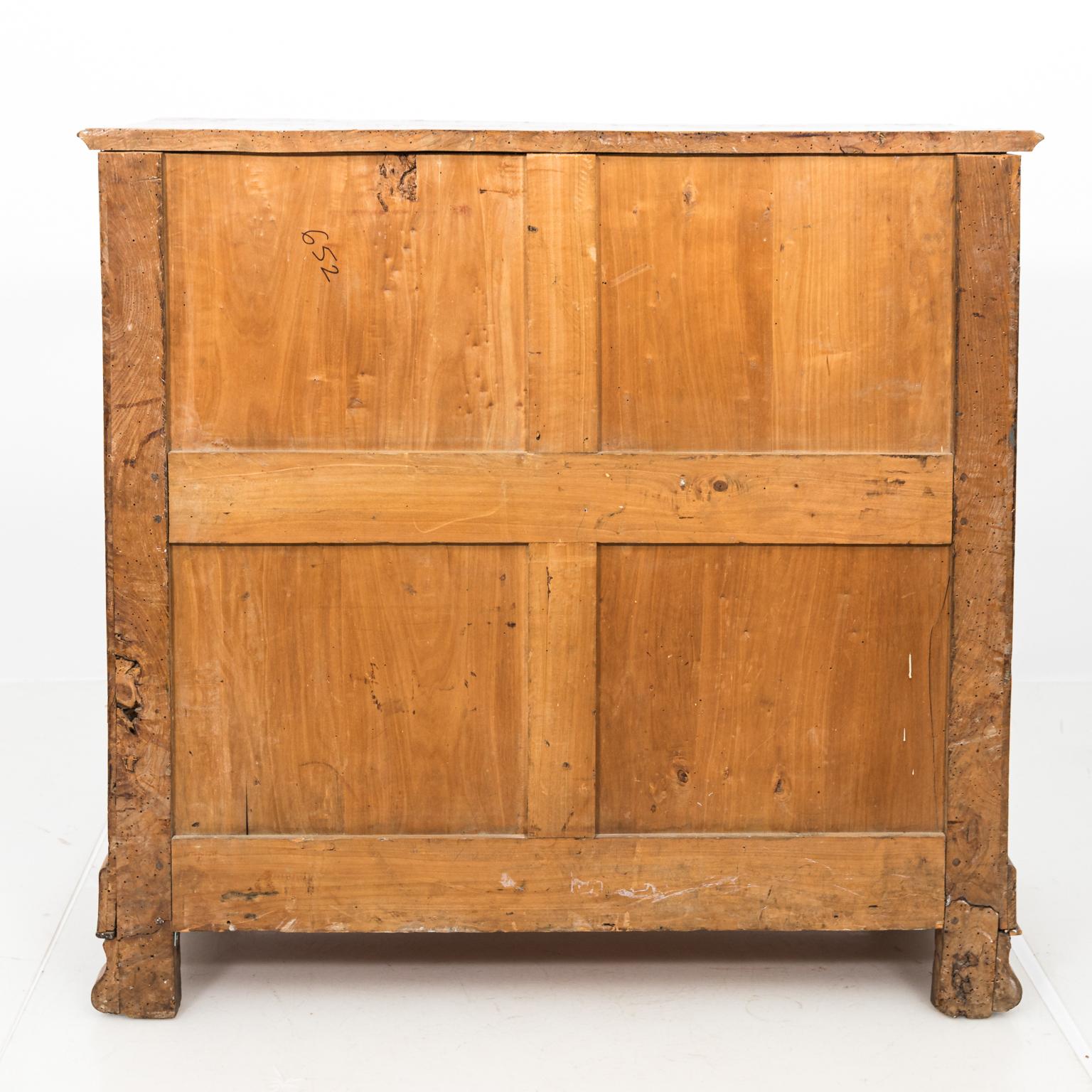 French four drawer chest with shield-shaped escutcheon, circa 1830s. Please note of wear consistent with age including repairs to the old veneer. There is also evidence of woodworm holes on the surface throughout. Weight more than 70 LBS. The piece