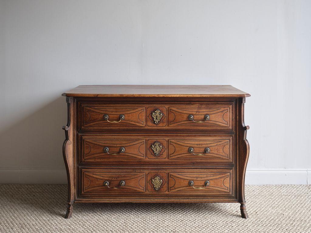 This stunning Walnut French commode, crafted in 1780, is in pristine condition and would make a huge statement in any room. It features beautiful curvatures and wood carved details. The hardware is all original and in great condition. Although it