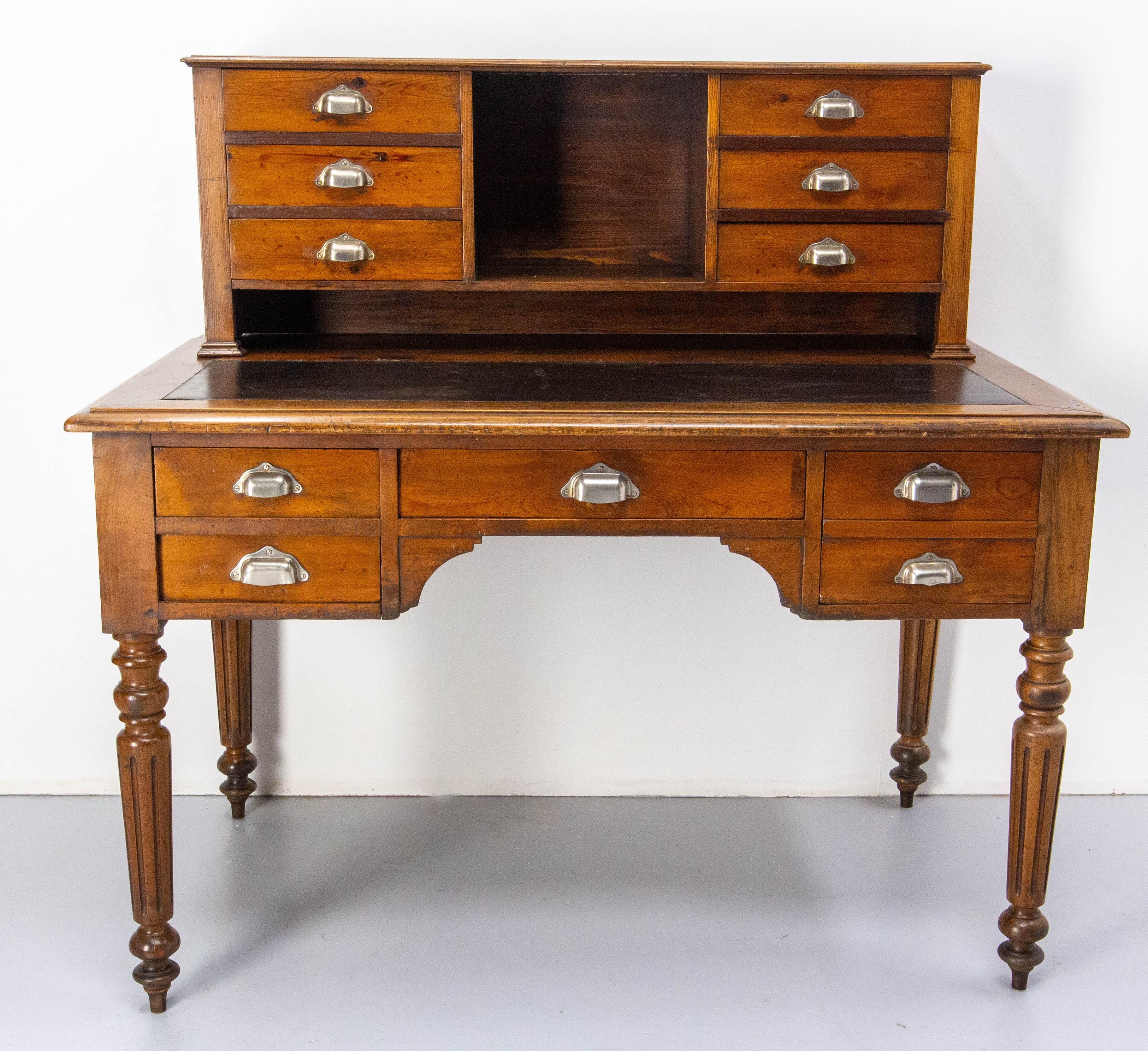 French 19th century Louis Philippe pine desk, the top is recovered of coated fabric.
Ten drawers of different size.

Table height: 31.50 in. (80 cm)
Height between the floor and the belt of the desk: 21.26 in. (54 cm)
Good condition.

Shipping: 
75