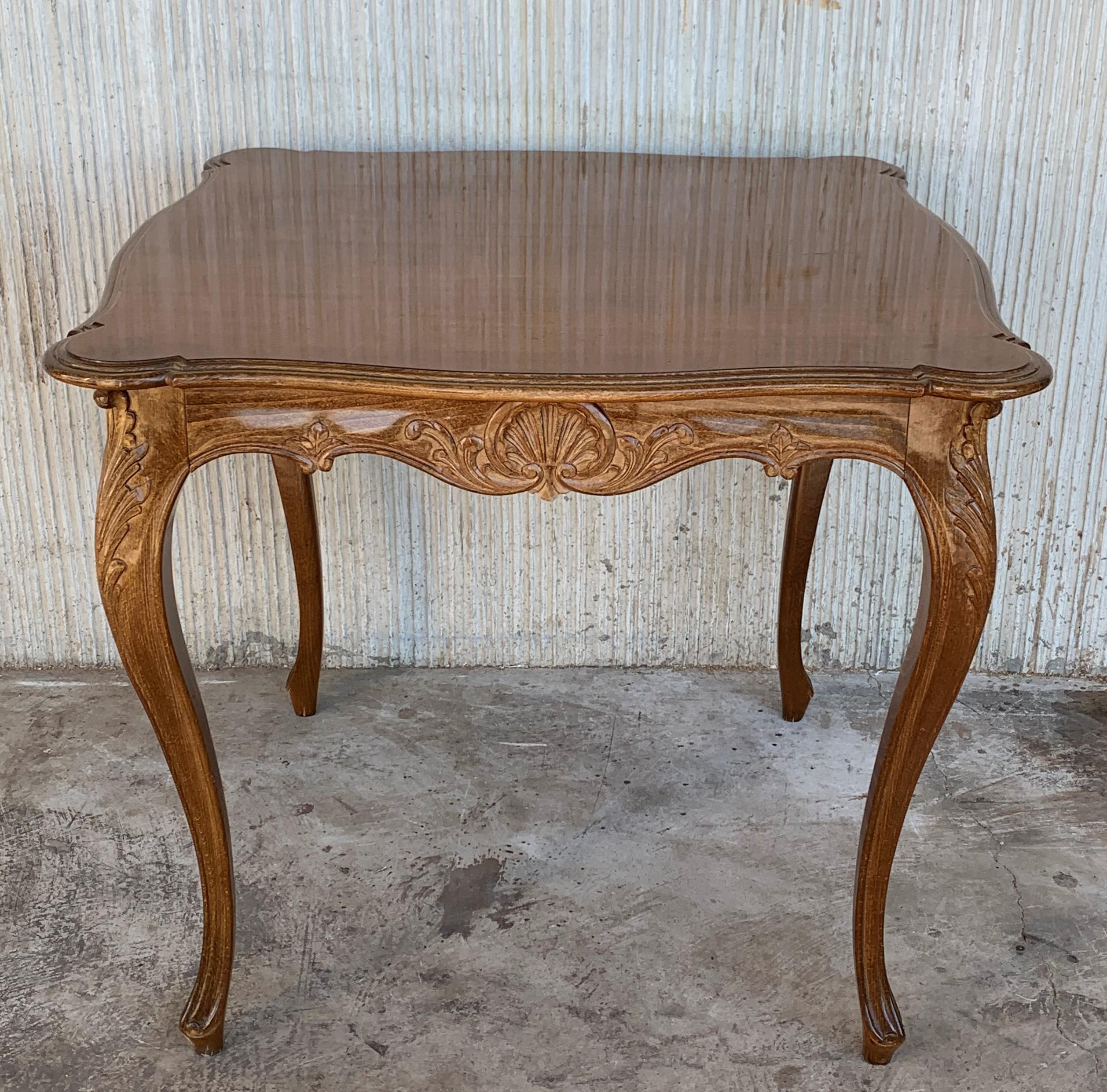 A beautifully carved French Louis XV or Rococo style walnut card table which can either be used as a center table, seats 4 people for games or card play. The table is raised on four carved cabriole legs and has a large drawer.