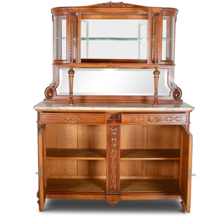 A fine-quality French Louis XVI buffet hutch in walnut, the base with two doors embellished with carved swags and raised on fluted and turned tapering legs, and with a marble top above two drawers. The upper display cabinet features bevelled glass