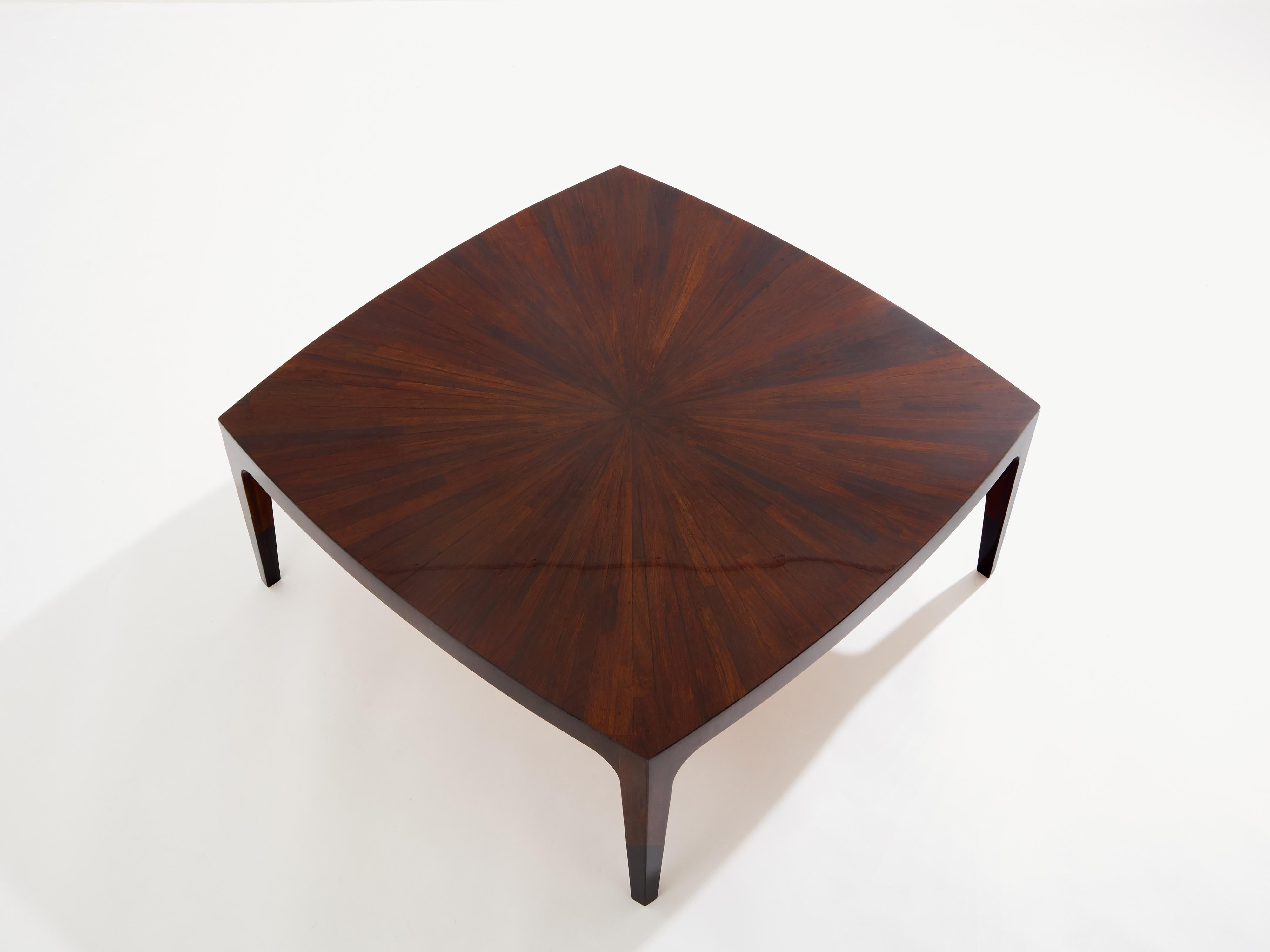 Beautiful coffee table made to order by an anonymous French cabinetmaker in the 1970s. Natural walnut as the chief material, the patterned marquetry on the table top creates a beautiful symmetry, with an organic aesthetic, while the slightly curved