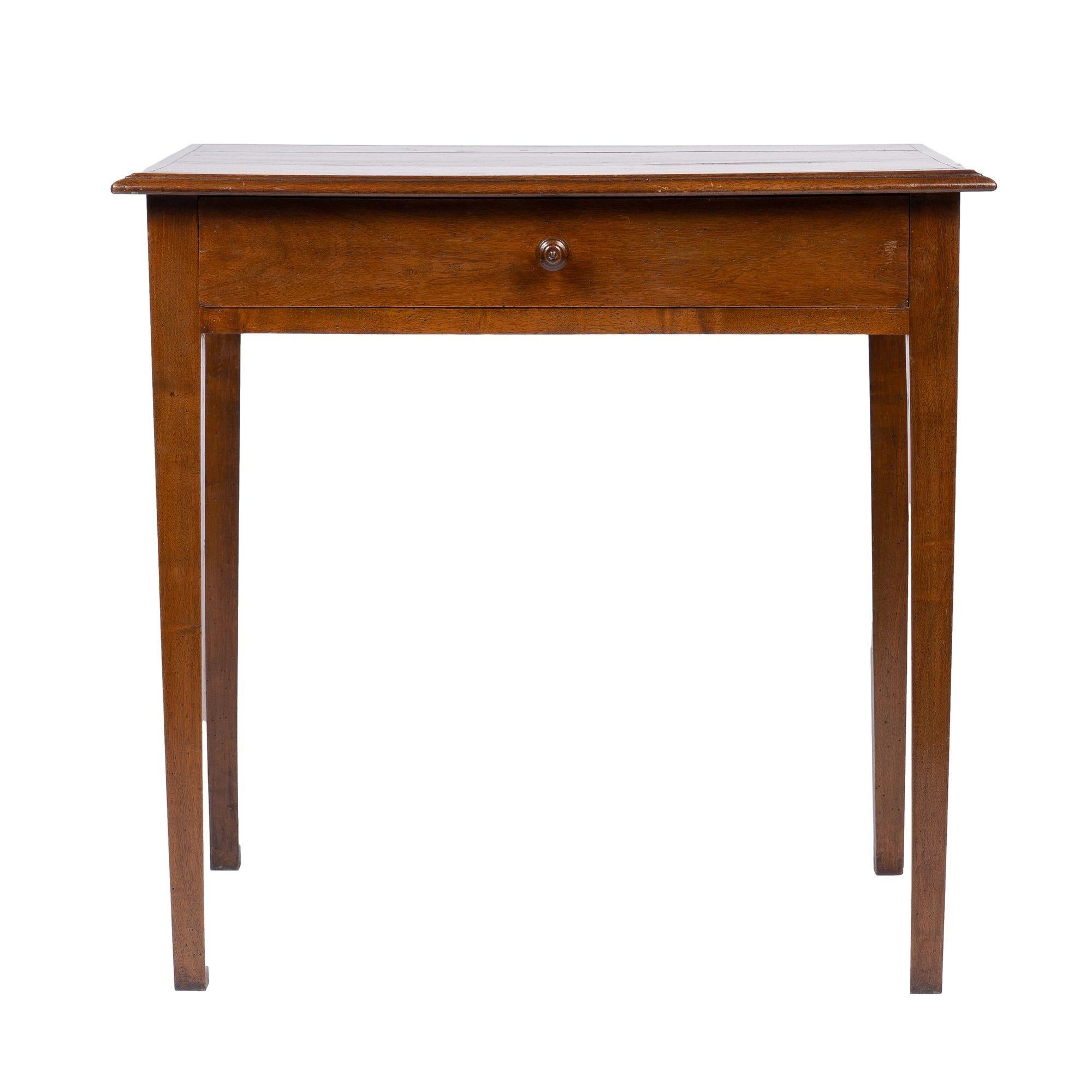 French walnut table on square tapered legs with a two board rectangular top framed by an applied ogee molding. The top is fitted onto a conforming apron with a wide shallow drawer.
France, early 1800’s.