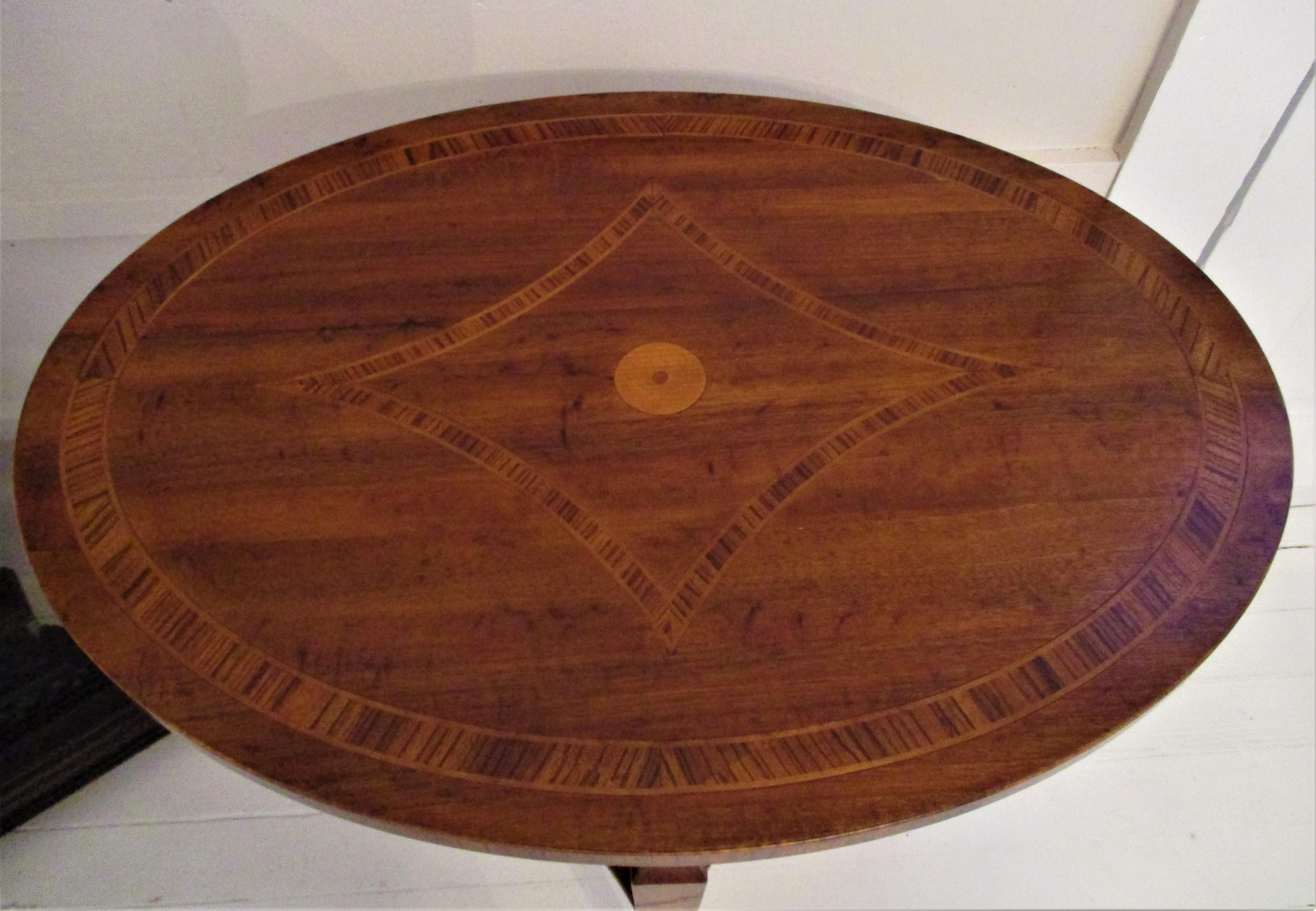 Mid-20th century French Walnut Oval Inlay XVI table with dual diamond inlay. This table is a work of art and beautiful from every angle.