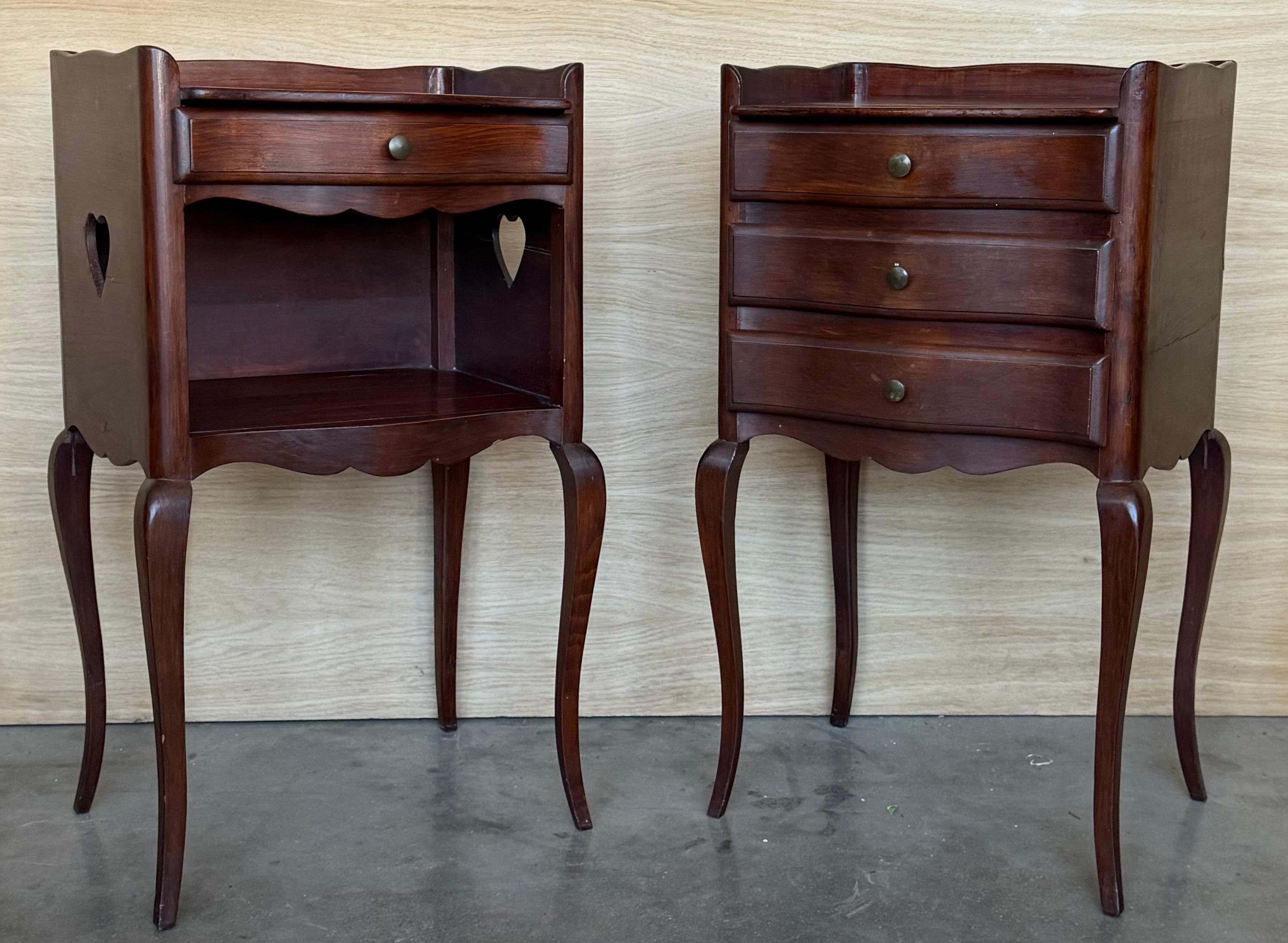 A French walnut bedside tables with one with  open shelf from the late with heart shape in both sides, the other one with three dovetailed drawers. This French 'table de chevet' features a rectangular top surrounded by a three-quarter wooden gallery