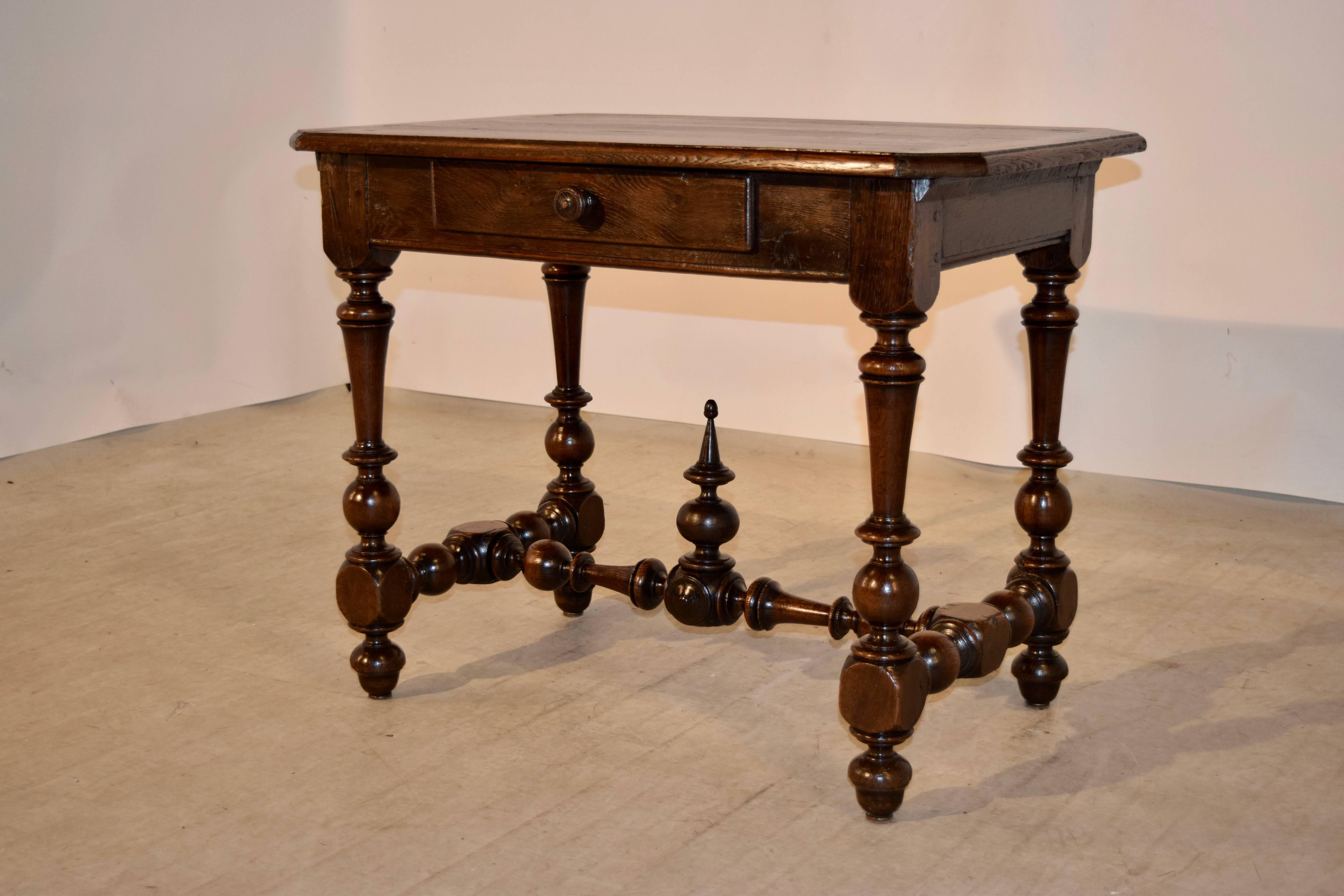 French side table made from walnut with a banded end top which has a bevelled edge following down to a simple apron which contains a single drawer in the front, circa 1800. The table is supported on hand turned legs which have shrinkage and nibbles,