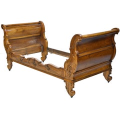 Antique French Walnut Sleigh Day Bed with Articulated Carvings in a Provincial Style