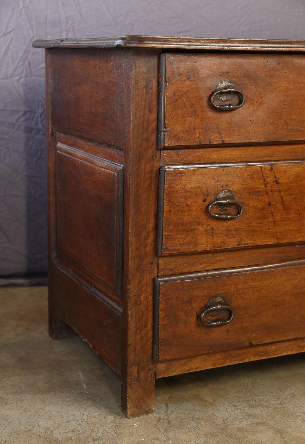 This French walnut three-drawer chest has a lovely hand waxed patina. Each of the three drawers has two iron pulls and a key hole, two of the drawers have a locking mechanism although no keys are available. A versatile piece in both form and