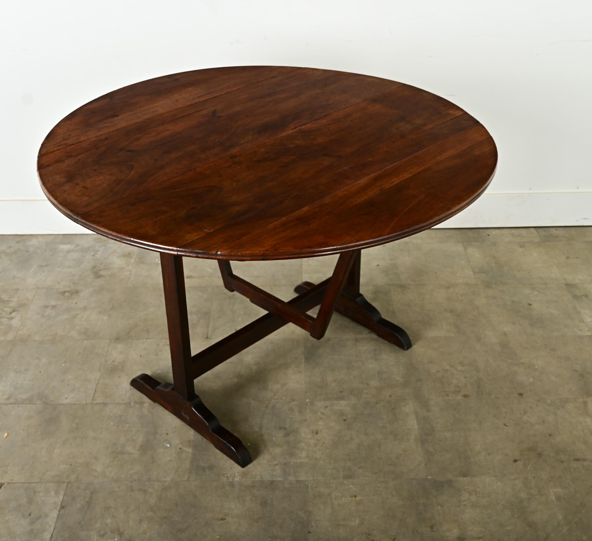 This wine tasting – or vendange – table from 19th century France, is handcrafted of walnut with gorgeous color and patina. Used by wine-makers throughout Europe, these specialized tables feature the ability to be stored away when not in use thanks